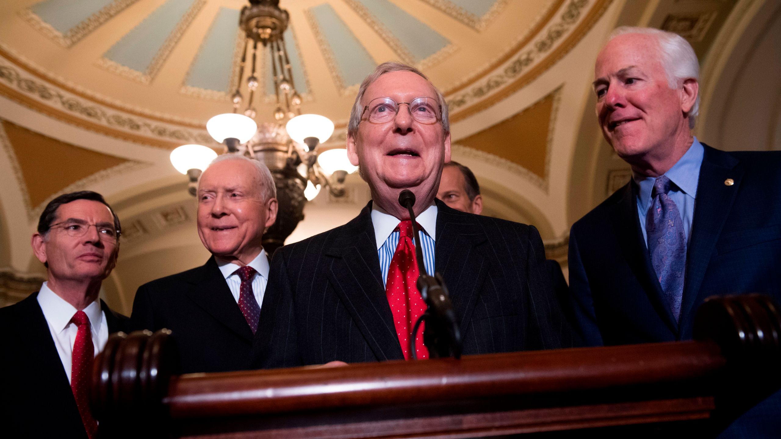 Senate Majority Leader Mitch McConnell alongside Senate Majority Whip John Cornyn (far right), Sen. John Barrasso (left) and Sen. Orrin Hatch (second left), speaks after a meeting between President Donald Trump and the Republican Senate Caucus in Washington, DC, Nov. 28, 2017. (Credit: Saul Loeb / AFP / Getty Images)