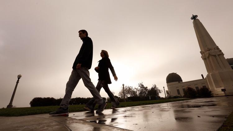 Stefan Campana and his mother, Marcia Campana, walk under the gray morning sky at Griffith Observatory on Nov. 27, 2017. (Credit: Al Seib / Los Angeles Times)