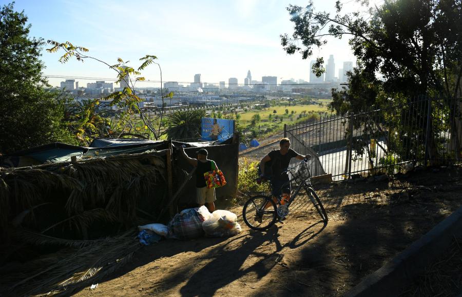 Lee Brown locks up his encampment in Elysian Park as his friend Billy Nelson heads to his encampment in November, 2017. (Credit: Wally Skalij / Los Angeles Times