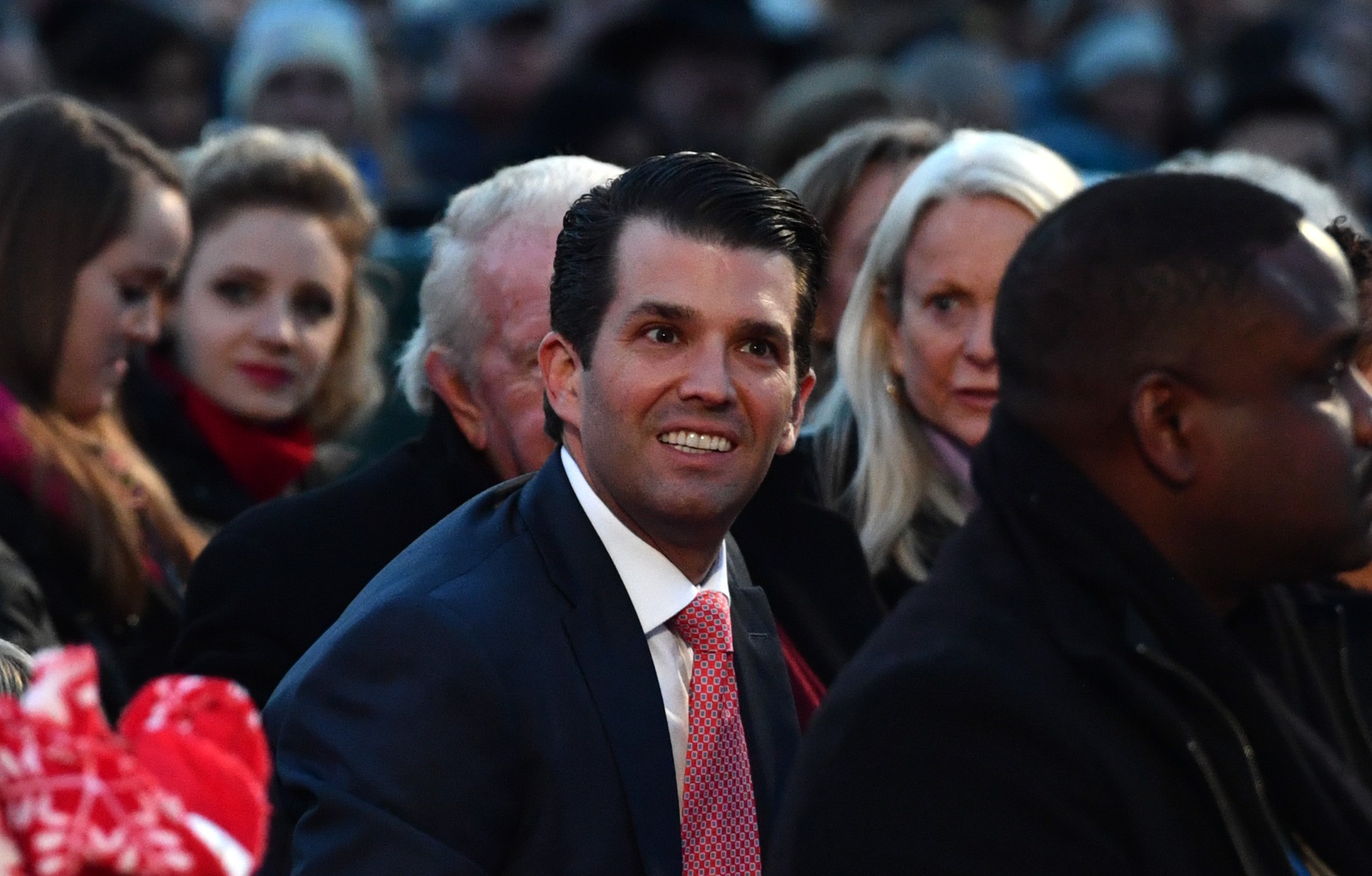 Donald Trump Jr. smiles as he waits for the arrival of President Donald Trump before the 95th annual National Christmas Tree Lighting ceremony near the White House on Nov. 30, 2017. (Credit: Nicholas Kamm / AFP / Getty Images)