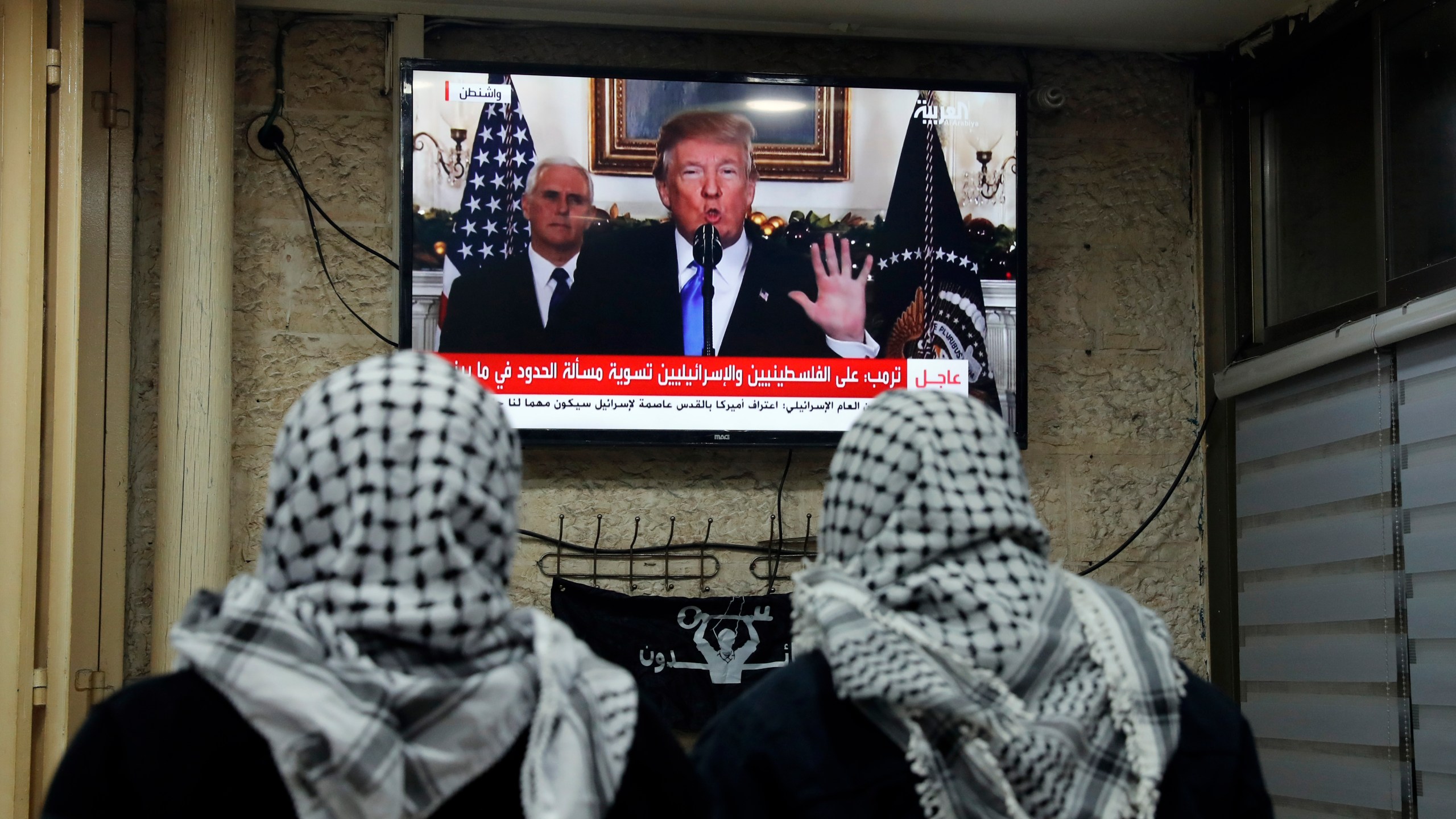 A photo taken on Dec. 6, 2017 shows Palestinian men watching an address given by Donald Trump at a cafe in Jerusalem. (Credit: AHMAD GHARABLI/AFP/Getty Images)