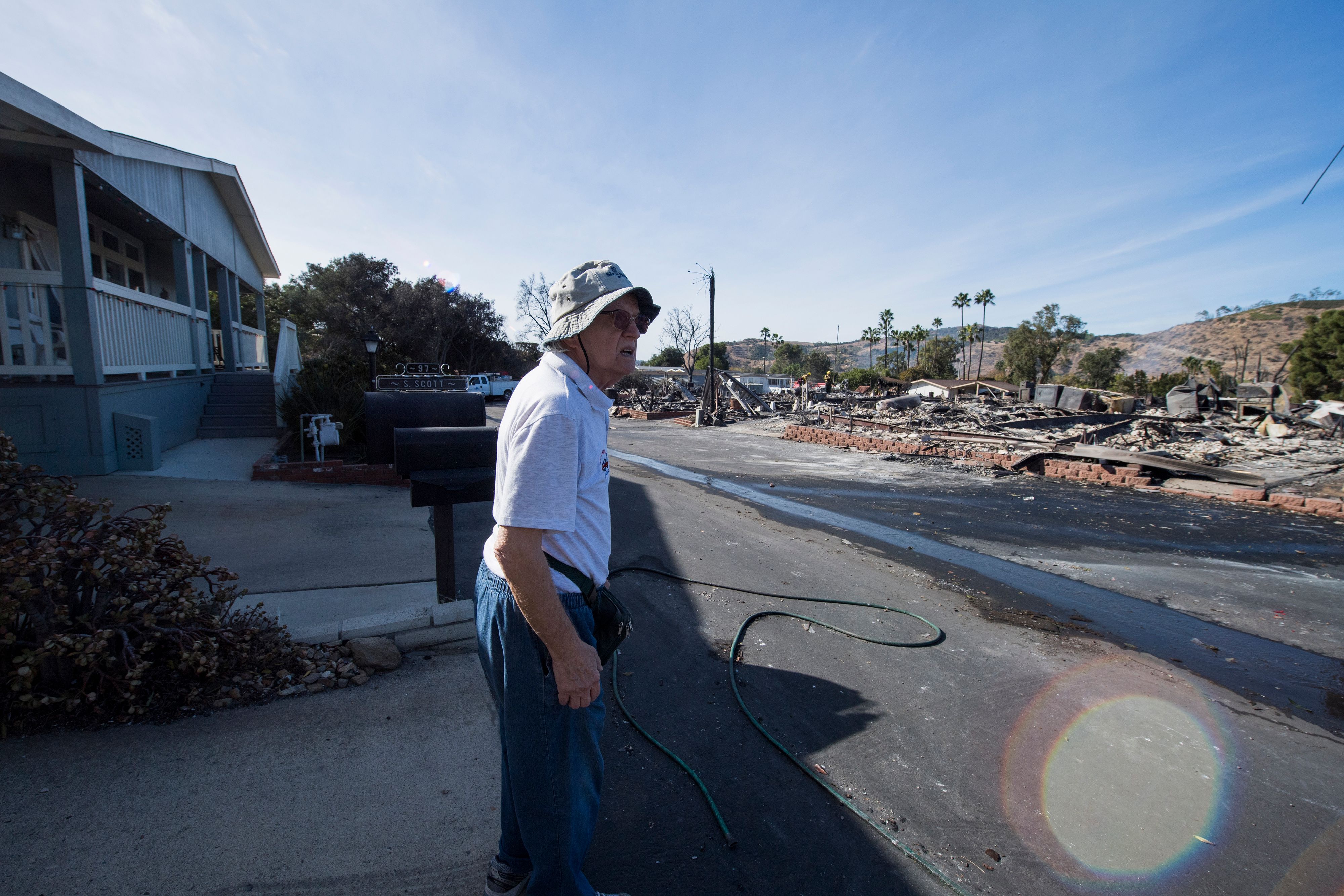 Local resident Pal Paricsy looks over the remains of his neighbors' homes destroyed by the Lilac Fire, Dec. 8, 2017, at a retirement community in Fallbrook, in San Diego County. (Credit: AFP PHOTO / Robyn Beck)