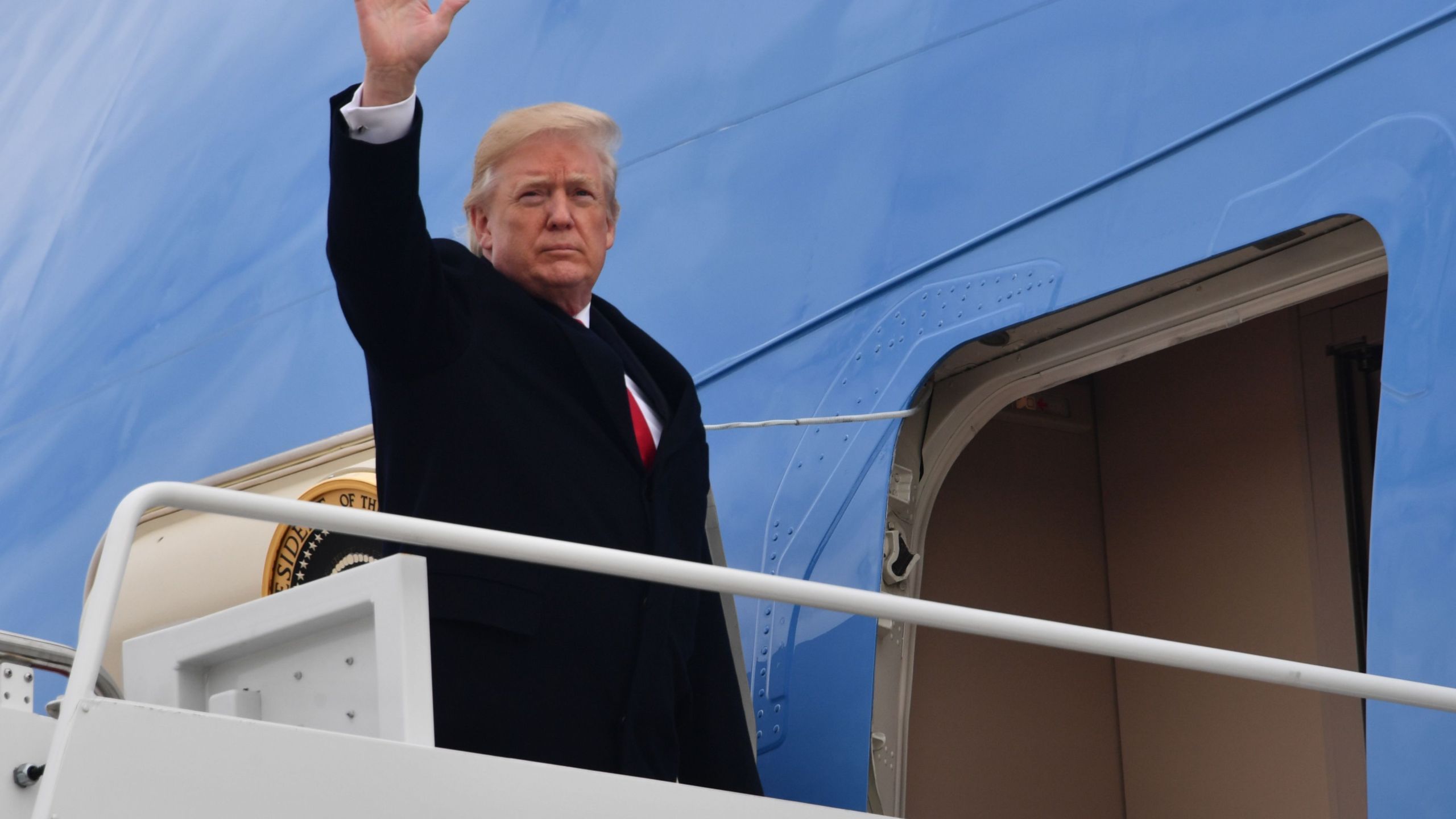 US President Donald J. Trump waves before boarding Airforce One at Joint Base Andrews, Maryland on December 22, 2017. (Credit: NICHOLAS KAMM/AFP/Getty Images)