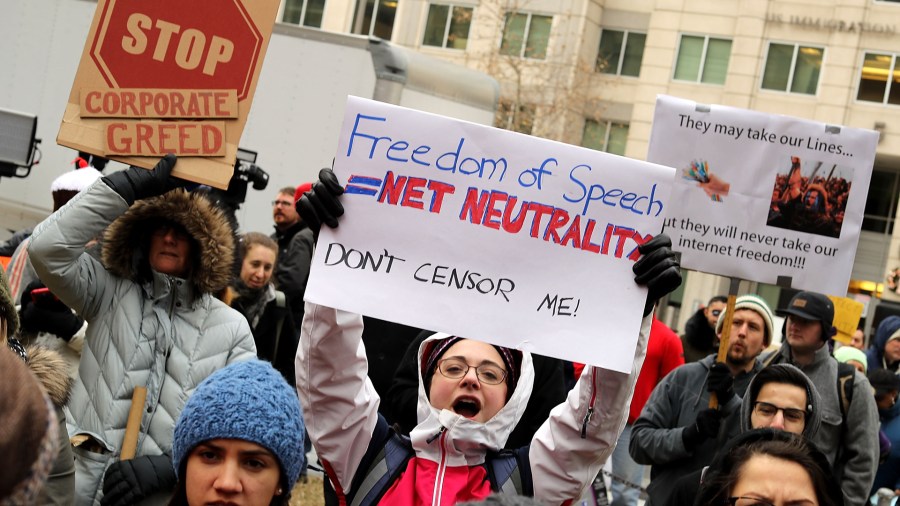 Demonstrators rally outside the Federal Communication Commission building to protest against the end of net neutrality rules on December 14, 2017 in Washington, DC. (Credit: Chip Somodevilla/Getty Images)