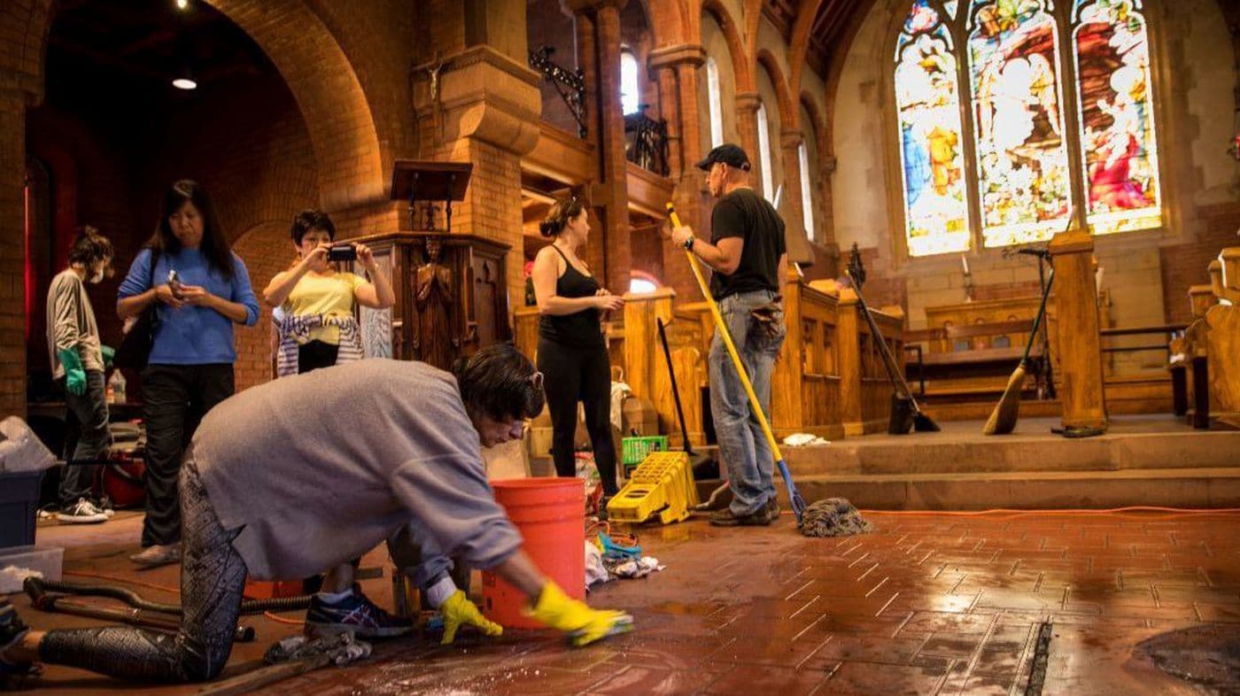 Community volunteers help clean damage caused by an arson fire started inside the Church of the Angels in Pasadena on Jan. 13, 2018. (Jay L. Clendenin / Los Angeles Times)