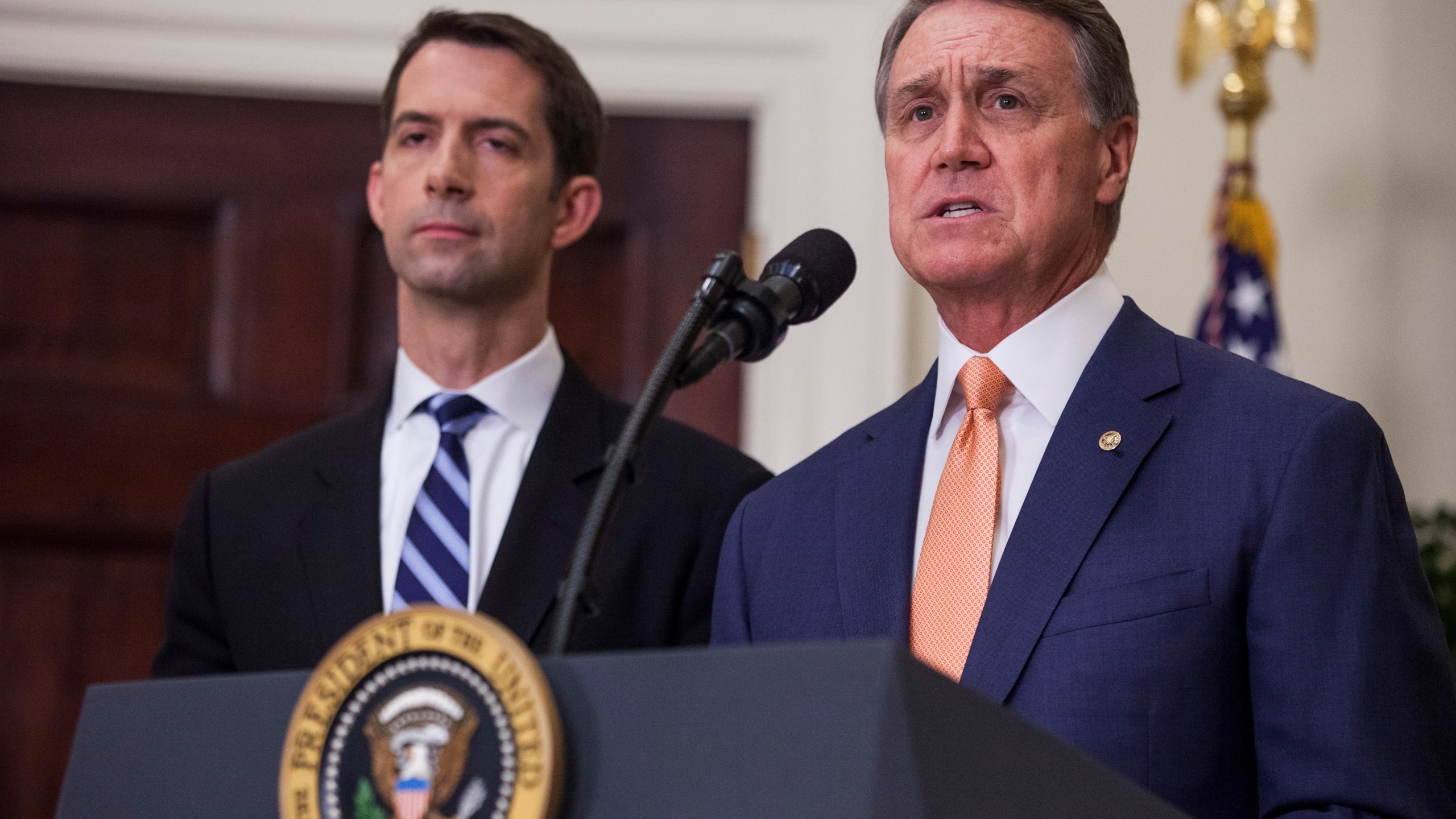 Sen. David Perdue (R-GA), pictured with makes an announcement on the introduction of the Reforming American Immigration for a Strong Economy Act in the Roosevelt Room at the White House on Aug. 2, 2017 in Washington, DC. Sen. Tom Cotton (R-AR).(Credit: Zach Gibson - Pool/Getty Images)