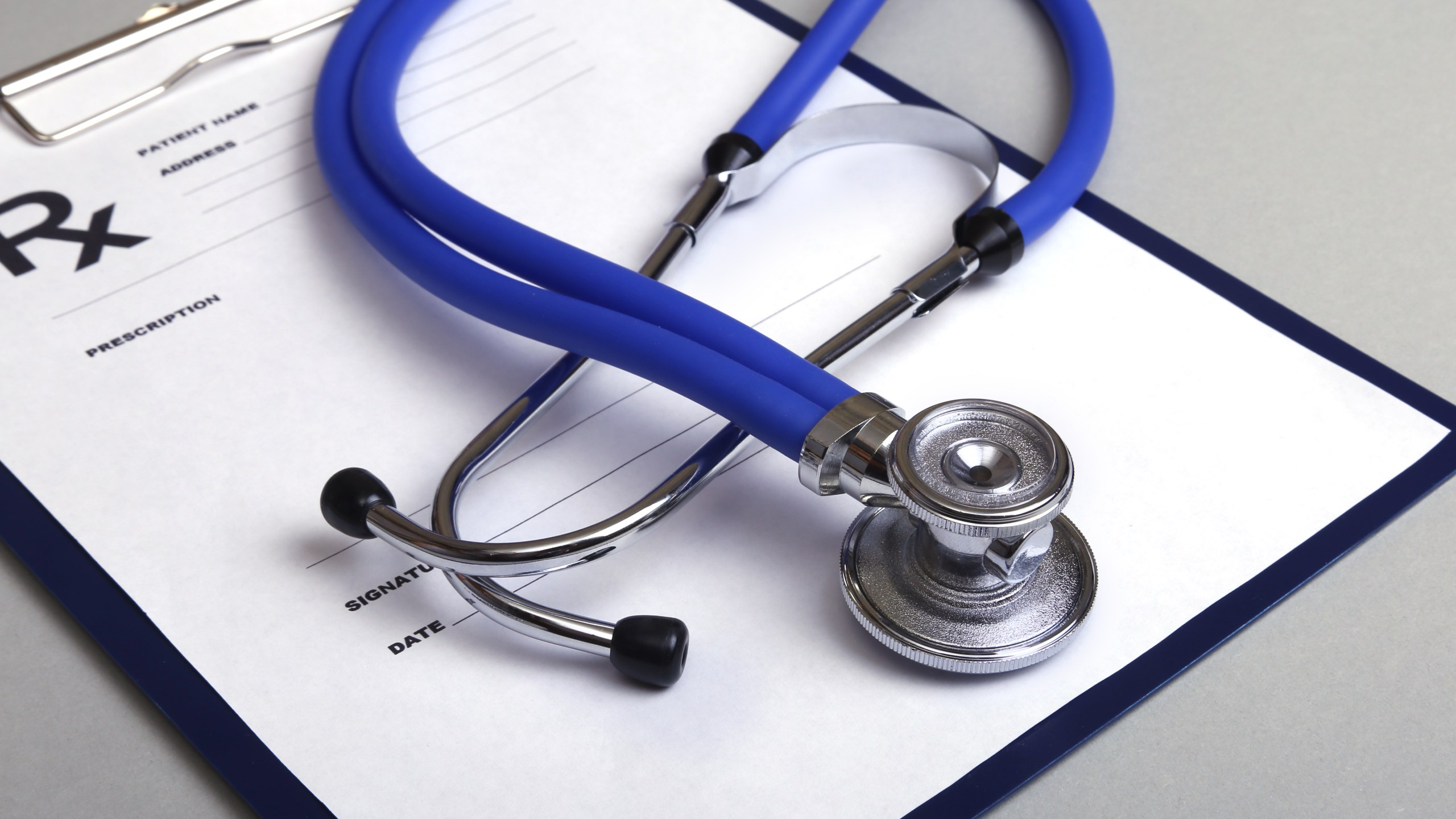 RX prescription and a stethoscope on white background. (Credit: iStock/Getty Images Plus)