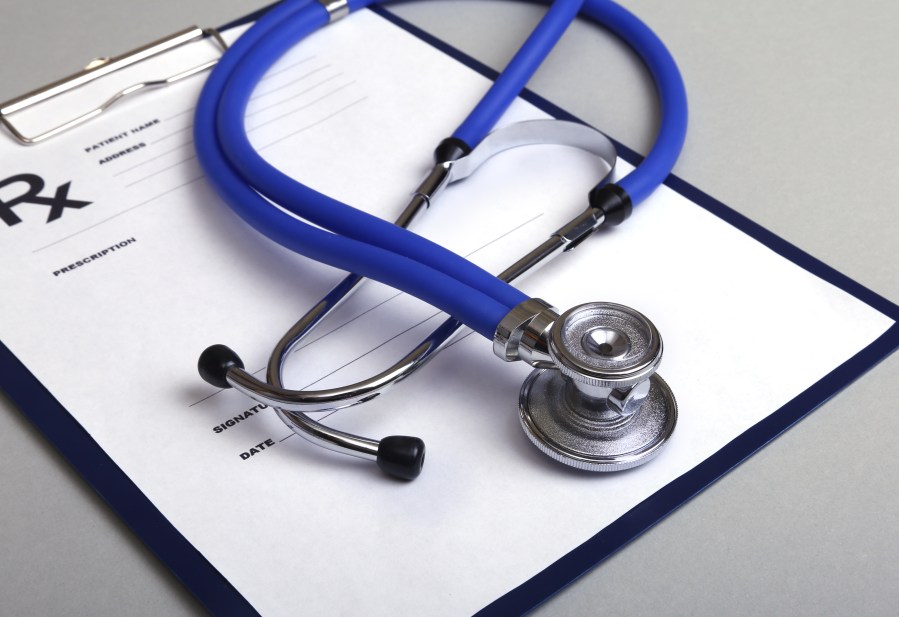 RX prescription and a stethoscope on white background. (Credit: iStock/Getty Images Plus)