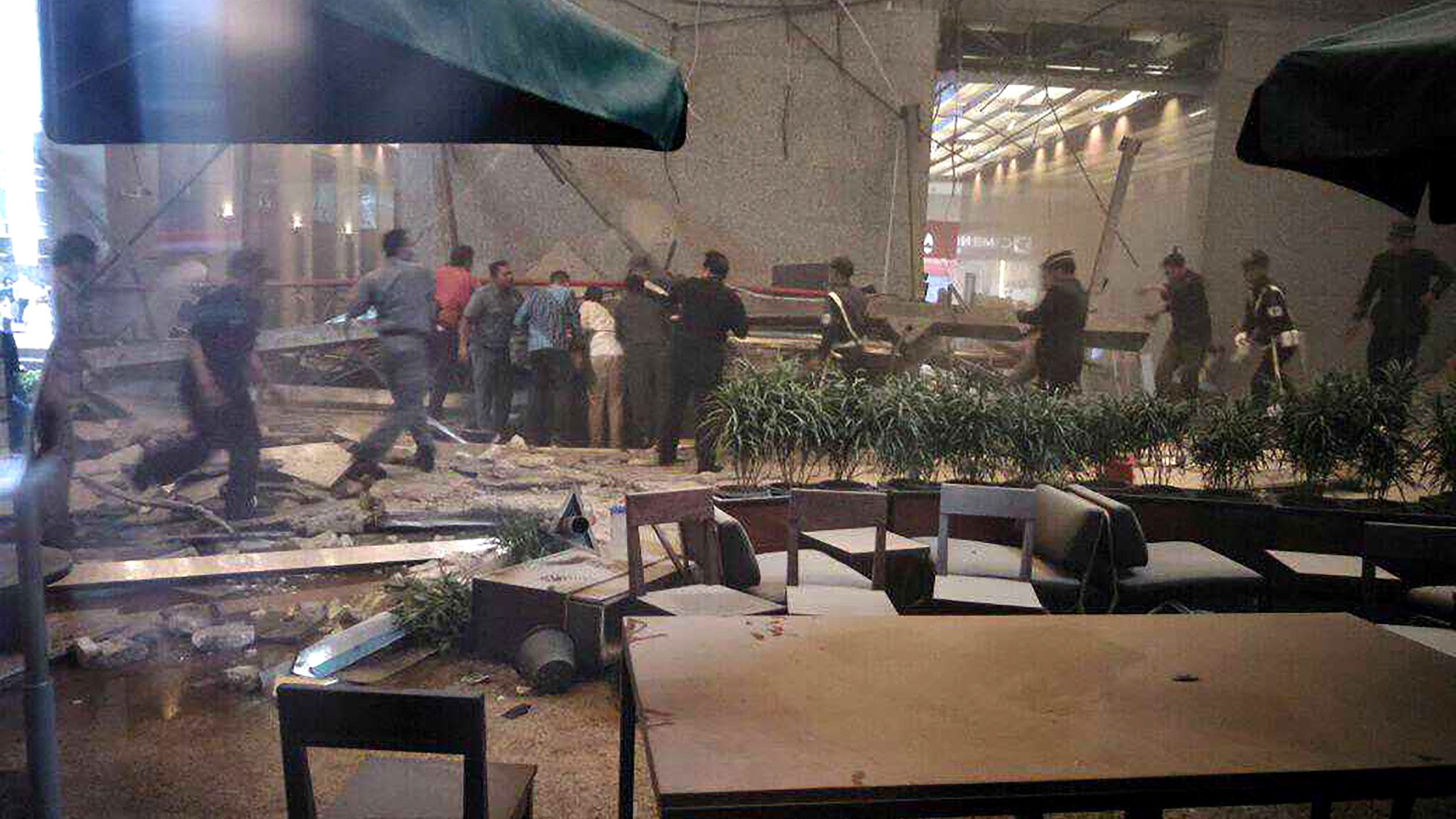 This photo received from Amailia Putri Hasniawati via WhatsApp shows people looking for victims after an internal balcony collapsed at Indonesia's stock exchange in Jakarta on Jan. 15, 2018.