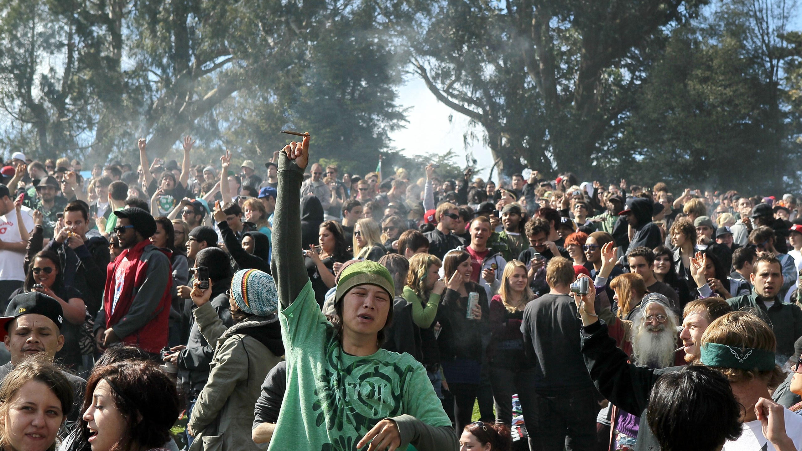 A cloud of smoke rests over the heads of a group of people during a 420 Day celebration on "Hippie Hill" in Golden Gate Park April 20, 2010, in San Francisco. (Credit: Justin Sullivan/Getty Images)