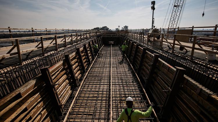 Construction workers at a viaduct being built to extend over State Route 99 and North and Cedar Avenues in Fresno County in this undated photo. (Credit: Marcus Yam / Los Angeles Times)