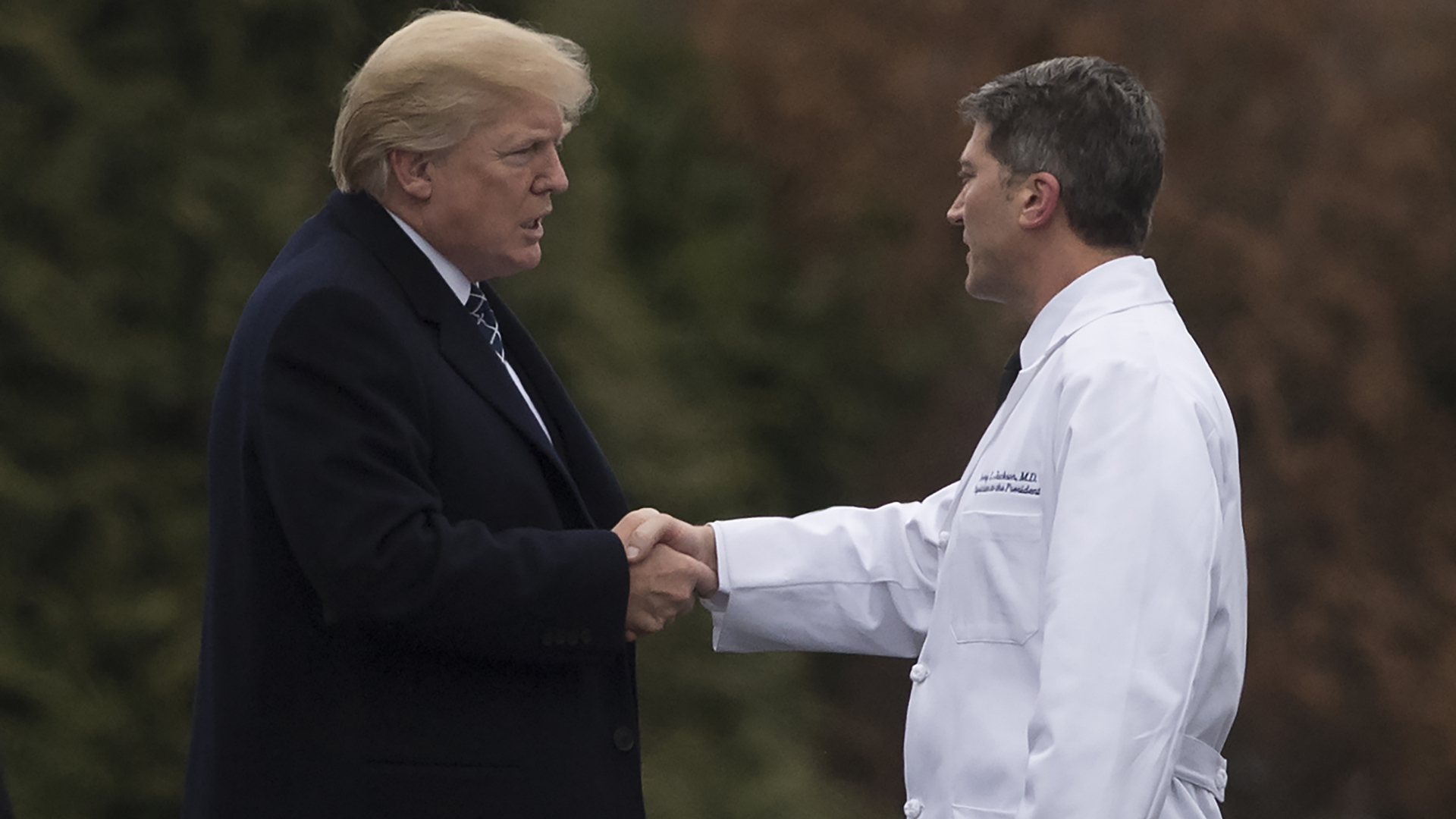 President Donald Trump shakes hands with White House Physician Rear Admiral Dr. Ronny Jackson, following his annual physical at Walter Reed National Military Medical Center in Bethesda, Maryland, January 12, 2018. (Credit: SAUL LOEB/AFP/Getty Images)