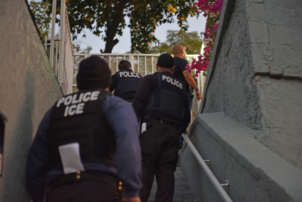 U.S. Immigration and Customs Enforcement agents are seen at a residence in Los Angeles in a photo released by the federal agency on Feb. 11, 2018.