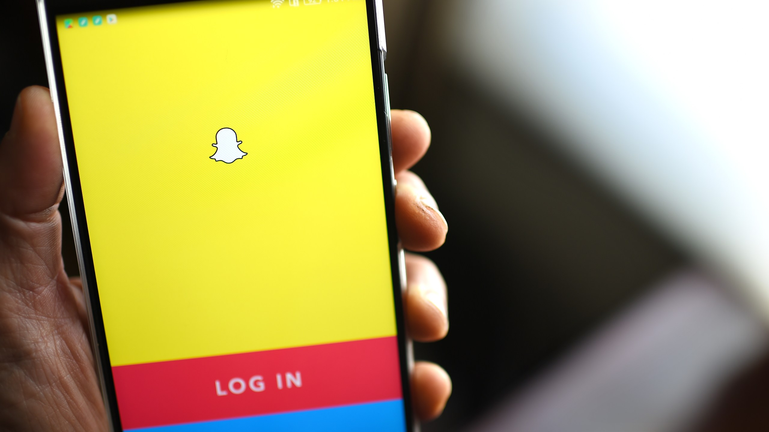 The Snapchat log-in page is displayed on a mobile phone. (Credit: ROBYN BECK/AFP/Getty Images)