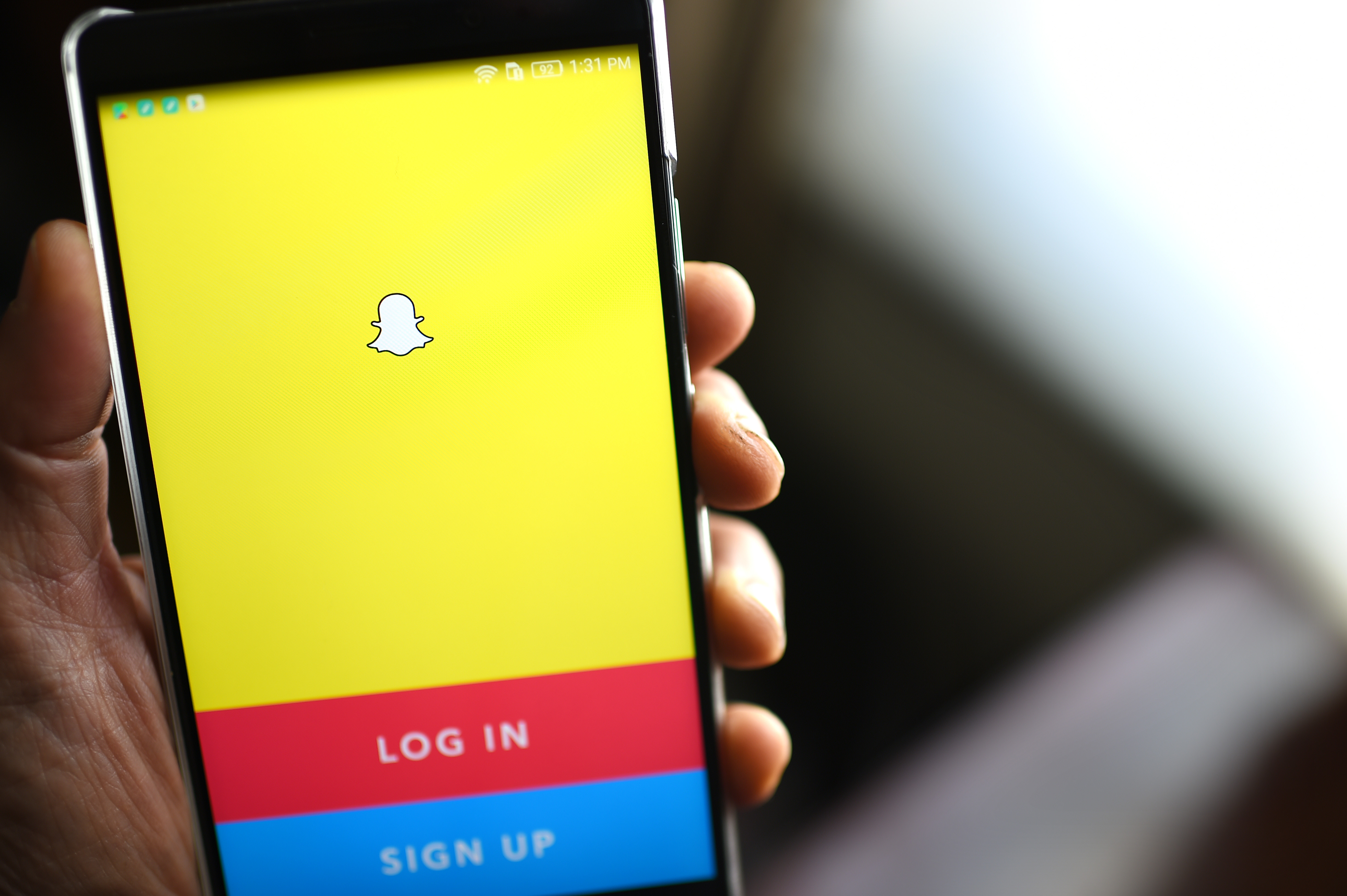 The Snapchat log-in page is displayed on a mobile phone. (Credit: ROBYN BECK/AFP/Getty Images)