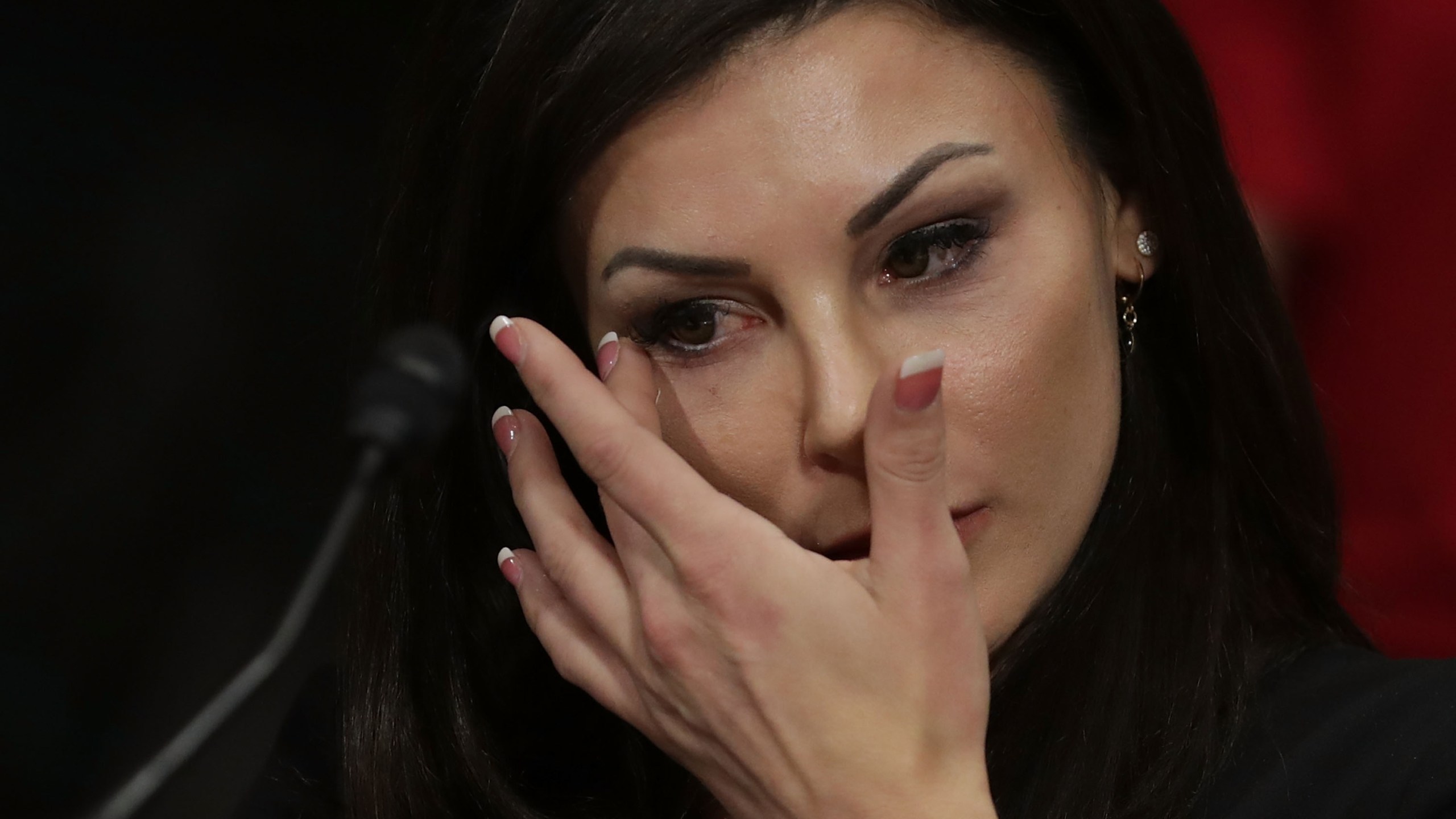 Jamie Dantzscher, former gymnast and 2000 Olympic bronze medalist, wipes away tears while testifying before the Senate Judiciary Committee about her sexual abuse at the hands of doctor Larry Nassar during a hearing in the Dirksen Senate Office Building on Capitol Hill, March 28, 2017. (Credit: Chip Somodevilla / Getty Images)