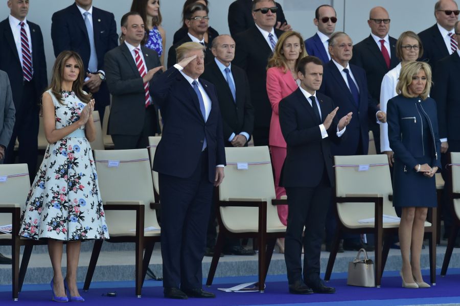 President Donald Trump salutes as French President Emmanuel Macron, his wife Brigitte Macron, and U.S. First Lady Melania Trump watch the annual Bastille Day military parade on the Champs-Elysees in Paris on July 14, 2017. (Credit: CHRISTOPHE ARCHAMBAULT/AFP/Getty Images)