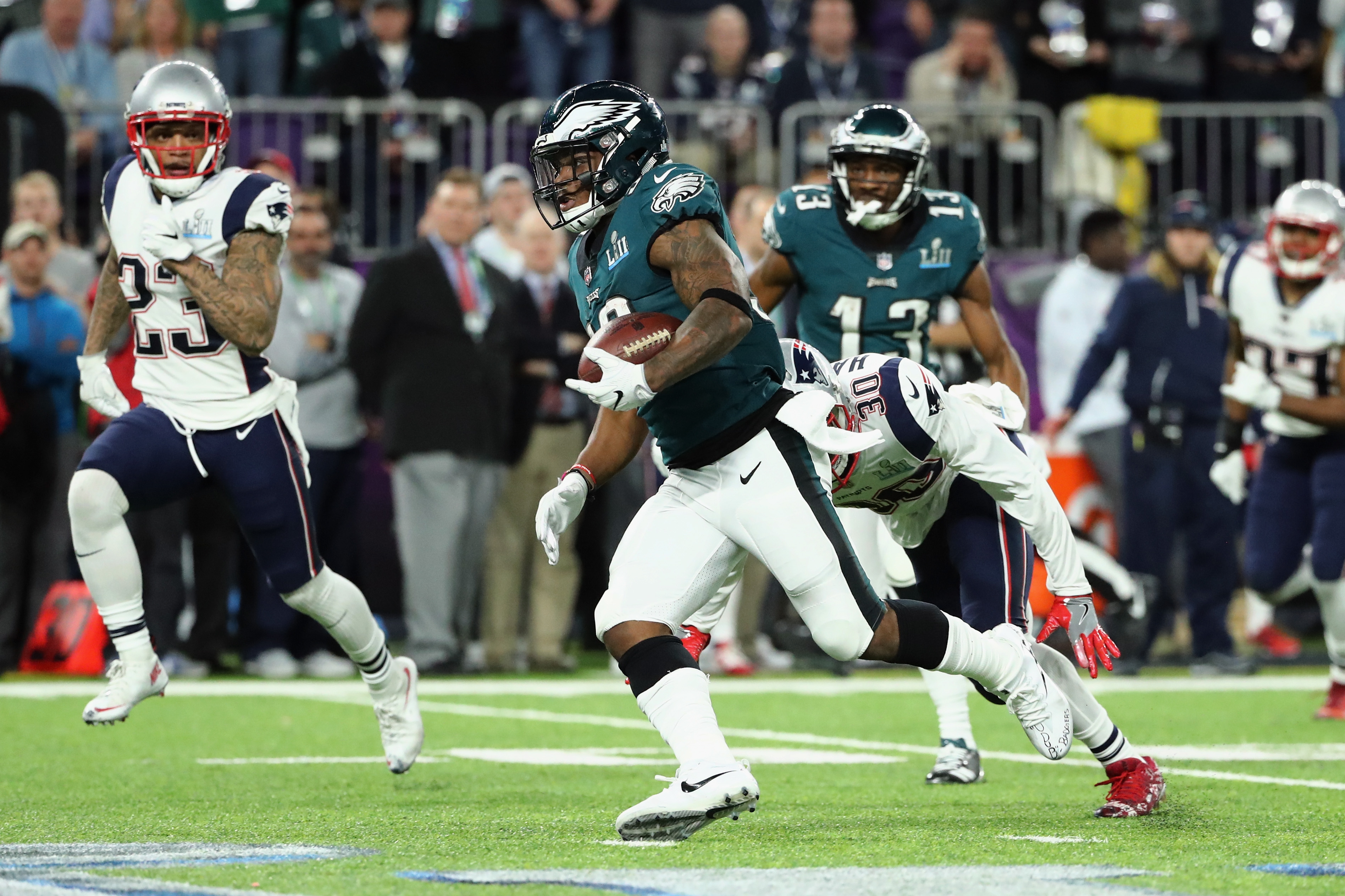 Corey Clement #30 of the Philadelphia Eagles carries the ball defended by Patrick Chung #23 and Duron Harmon #30 of the New England Patriots in the first half of Super Bowl LII at U.S. Bank Stadium on Feb. 4, 2018, in Minneapolis. (Credit: Elsa/Getty Images)