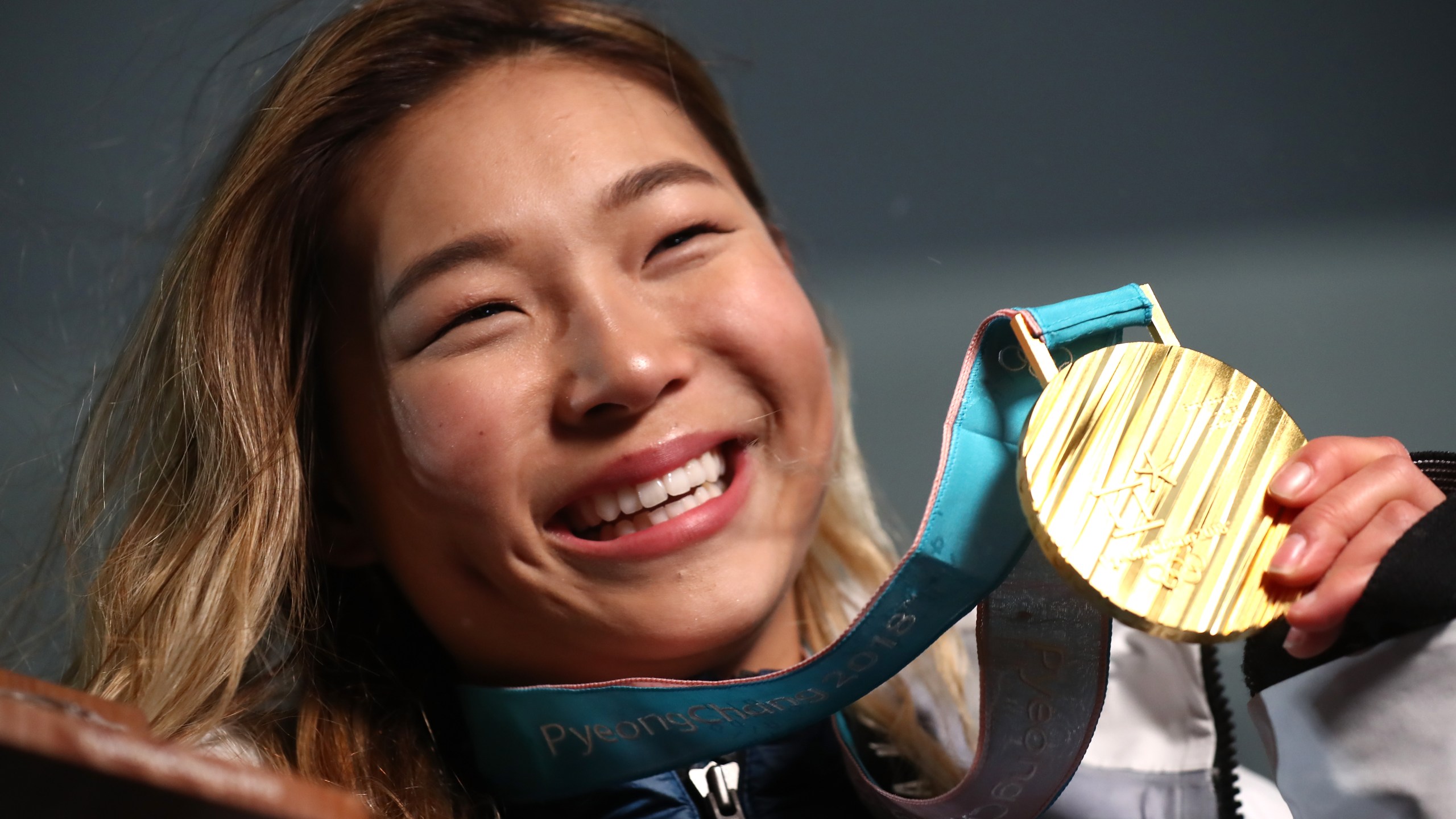 Gold medalist Chloe Kim of the United States poses during the medal ceremony for the snowboard ladies' halfpipe final in the PyeongChang 2018 Winter Olympic Games on Feb. 13, 2018. (Credit: Alexander Hassenstein / Getty Images)