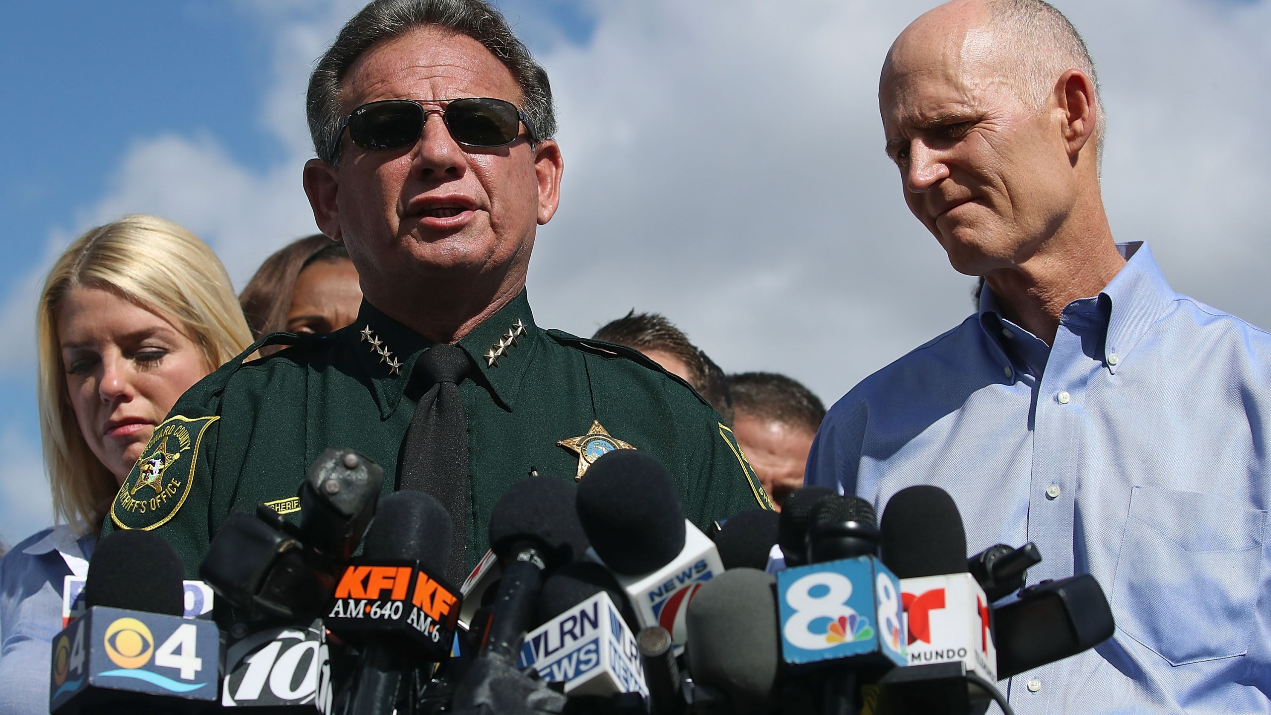 Broward County Sheriff Scott Israel, center, Florida Gov. Rick Scott, right, and Florida Attorney General Pam Bondi, left, speak to the media about the mass shooting at Marjory Stoneman Douglas High School on Feb. 15, 2018 in Parkland, Florida. (Credit: Mark Wilson/Getty Images)