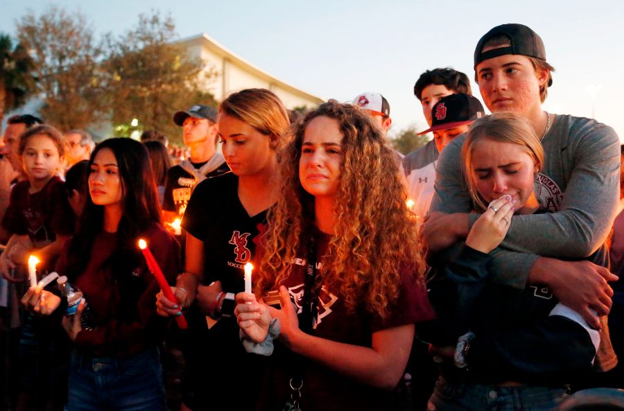 Mourners react during a candlelight vigil for the victims of Marjory Stoneman Douglas High School shooting in Parkland, Florida on Feb. 15, 2018. (Credit: RHONA WISE/AFP/Getty Images)