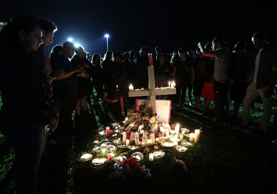 Students, friends and family gather to pray during a candlelight vigil for victims of the mass shooting at Marjory Stoneman Douglas High School, in Parkland, Florida, on Feb. 15, 2018. (Credit: Mark Wilson / Getty Images)