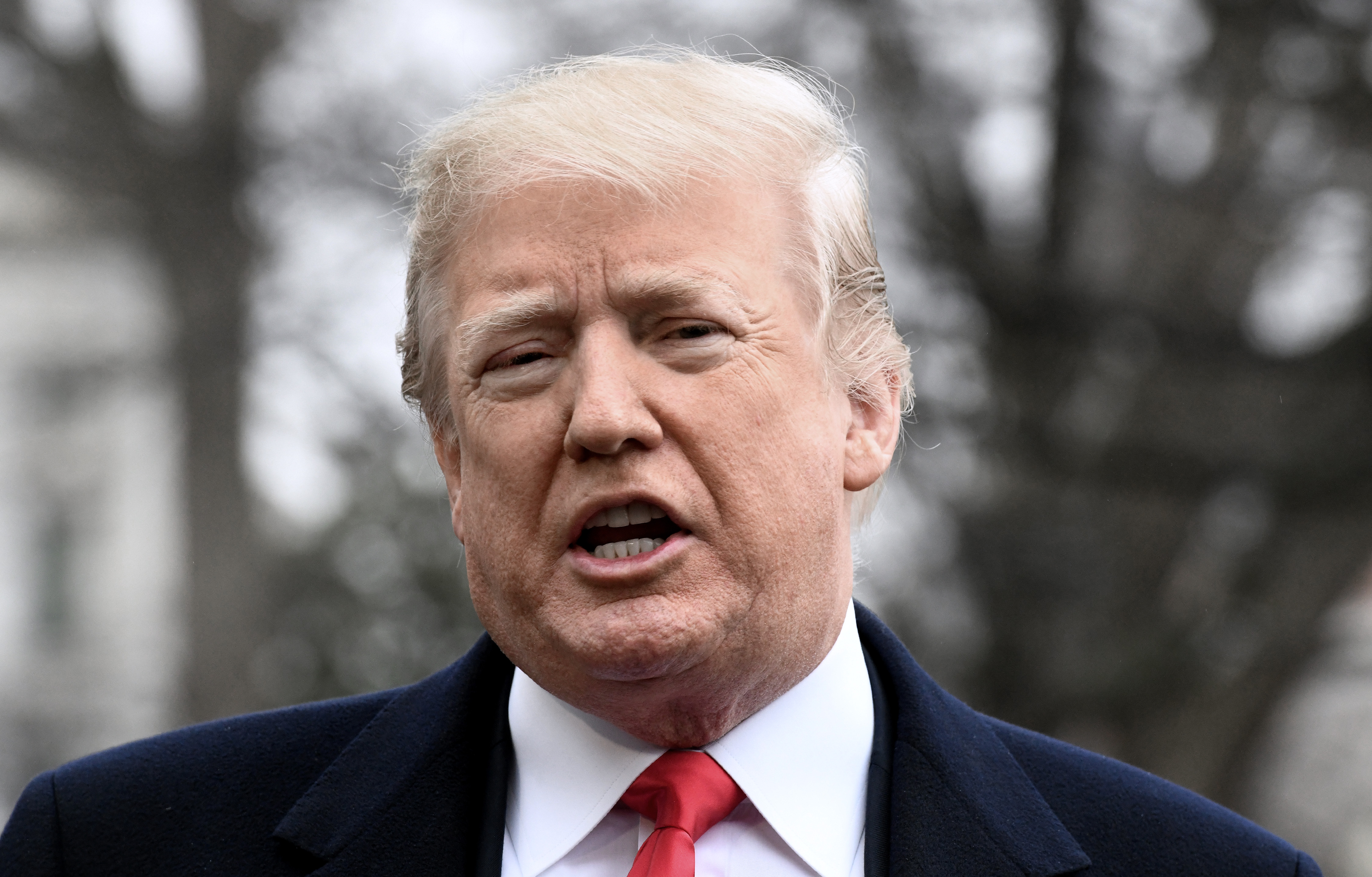 President Donald Trump takes questions from the media as he departs the South Lawn of the White House on February 23, 2018. (Credit: OLIVIER DOULIERY/AFP/Getty Images)