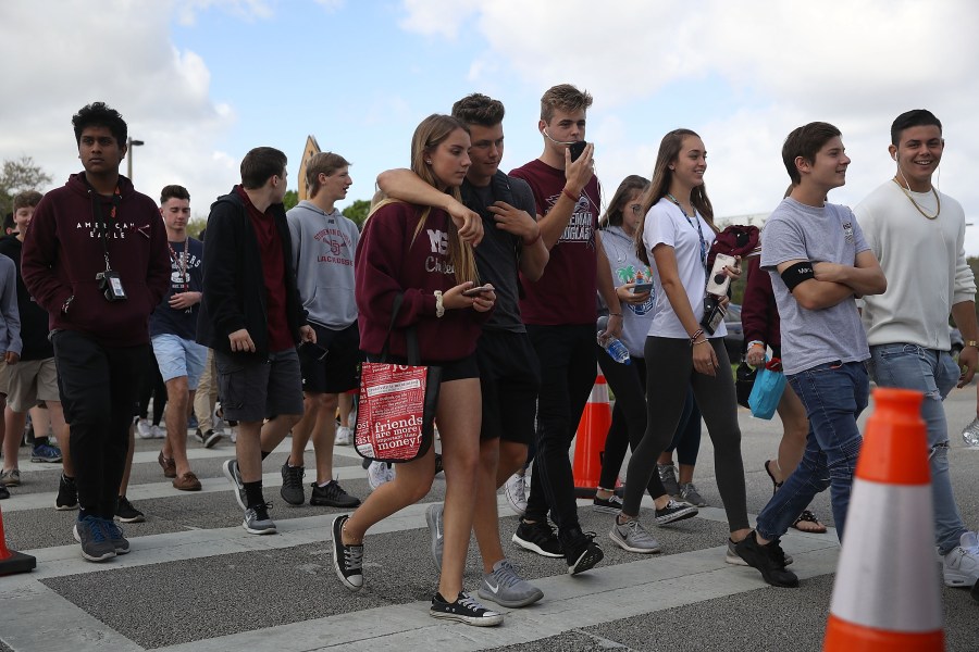 Students leave Marjory Stoneman Douglas High School after attending their classes for the first time since the shooting that killed 17 people at the school, Feb. 28, 2018, in Parkland, Florida. (Credit: Joe Raedle / Getty Images)