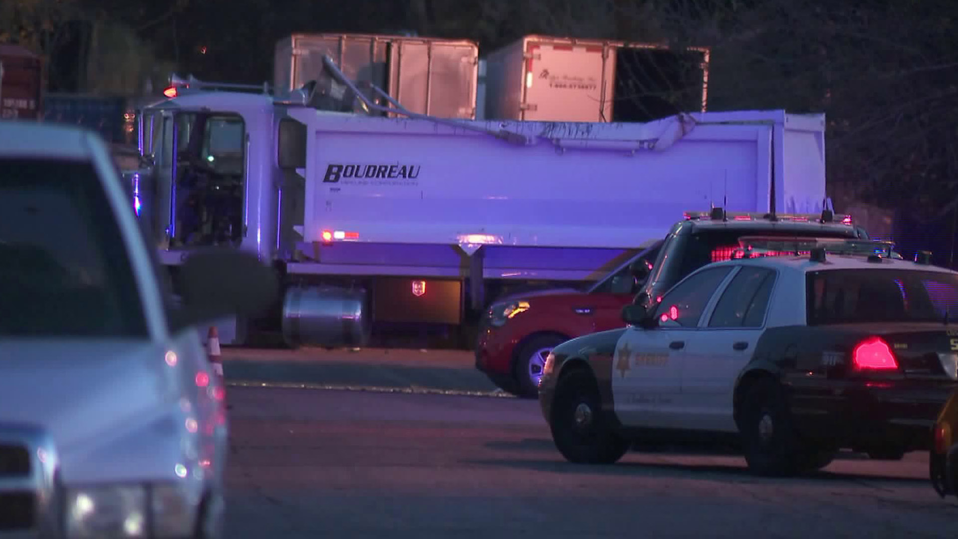 A truck and a Los Angeles County Sheriff's Department car are seen at a parking lot near Plaza Mexico in Lynwood on Feb. 25, 2018. (Credit: KTLA)