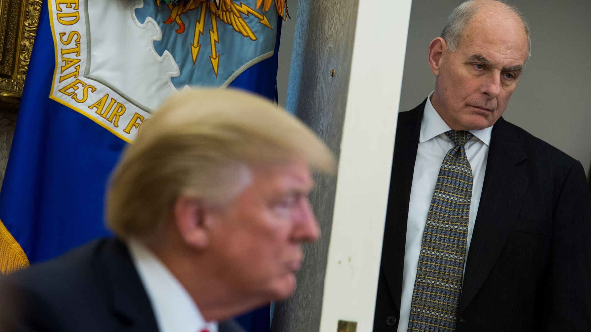 Chief of Staff John Kelly looks on as President Donald Trump meets with North Korean defectors in the Oval Office at the White House in Washington, DC on February 2, 2018. (Credit: ANDREW CABALLERO-REYNOLDS/AFP/Getty Images)