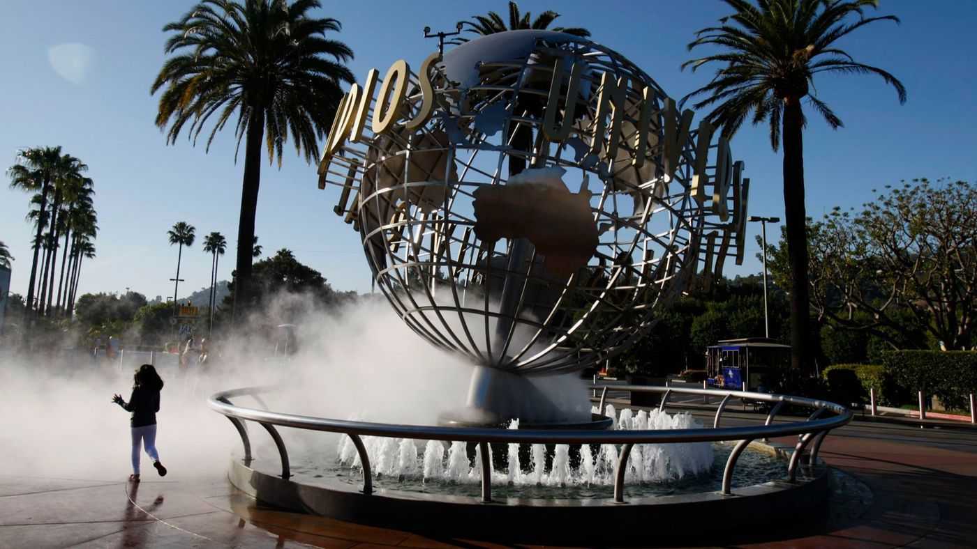 A child runs around the entrance to Universal Studios Hollywood before it opens on March 14, 2013. (Credit: Gary Friedman / Los Angeles Times)