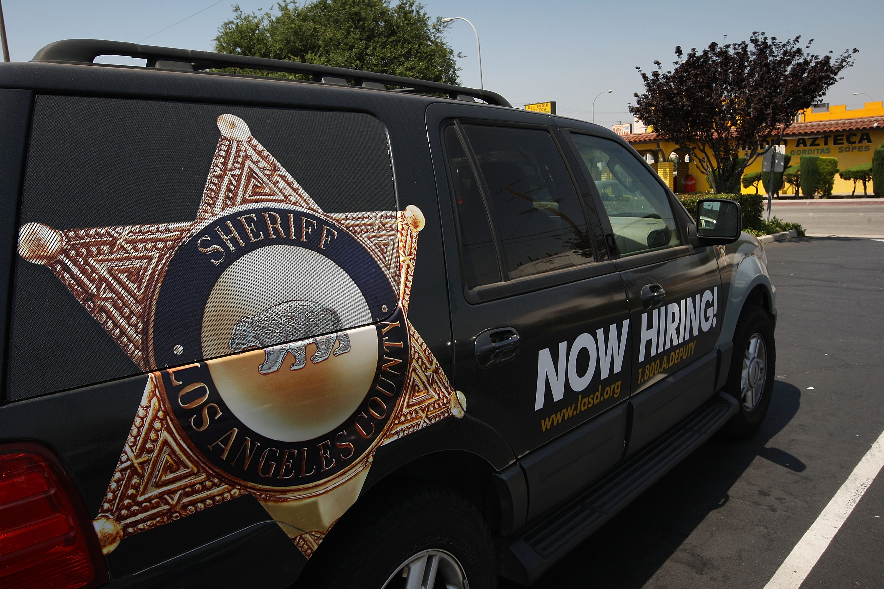 A Los Angeles County sheriff's vehicle that advertises for recruits is parked in the parking lot of the Maywood Police Department as deputies make plans to take over the facility on June 23, 2010. (Credit: David McNew/Getty Images)