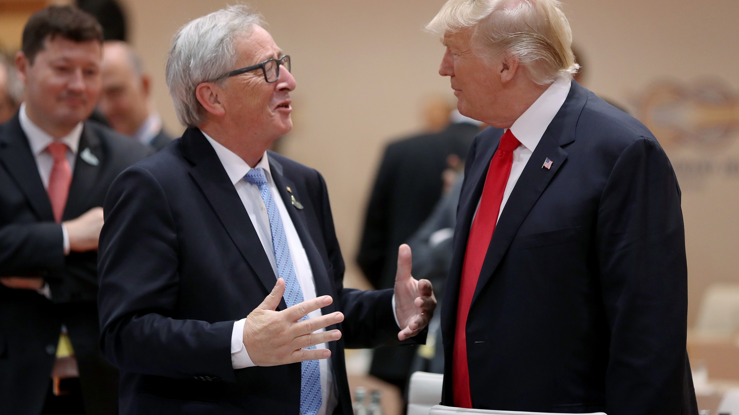 U.S. President Donald Trump, right, and European Commission President Jean-Claude Juncker chat at the G20 economic summit on July 8, 2017 in Hamburg, Germany. (Credit: Sean Gallup/Getty Images)