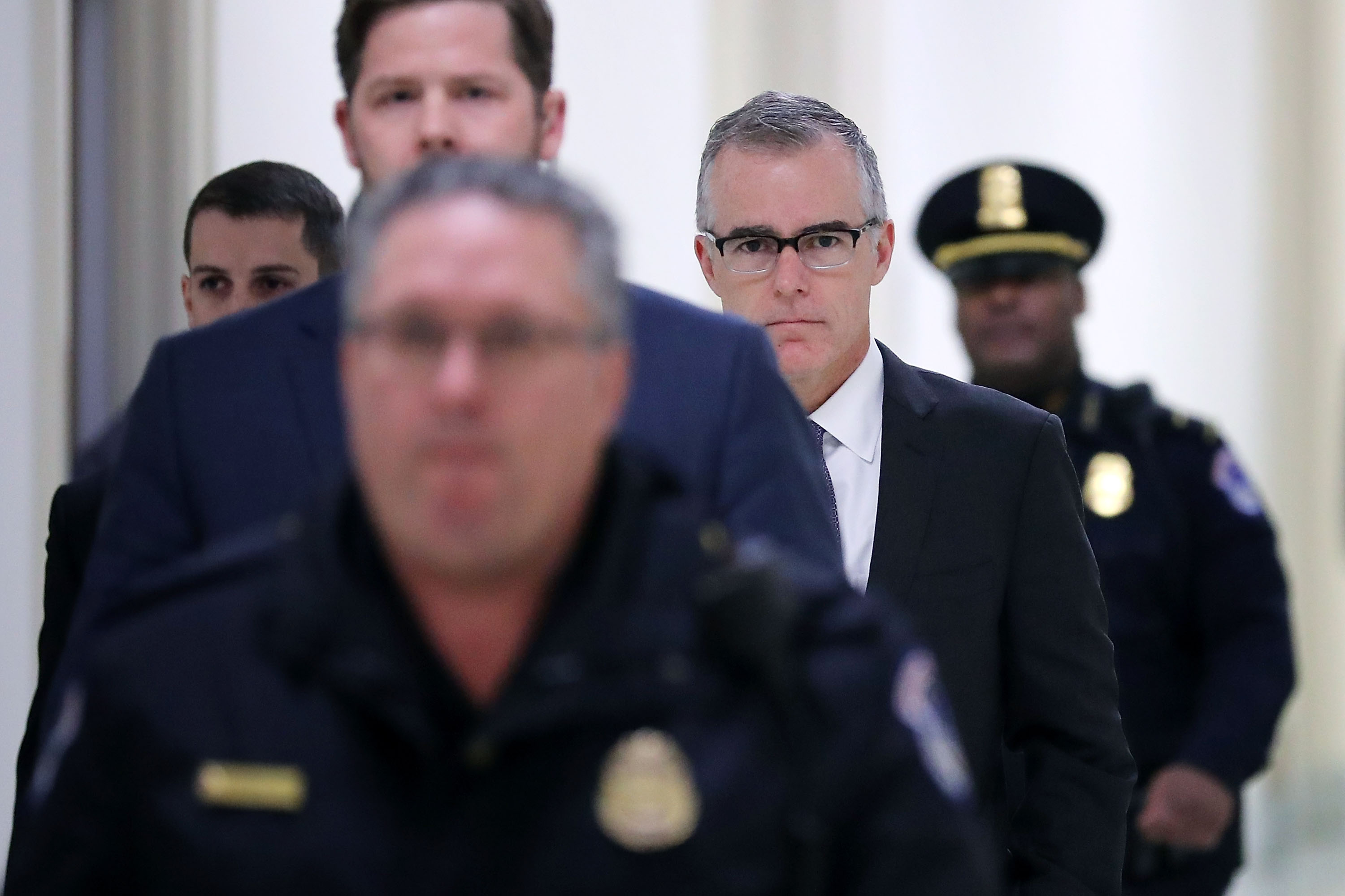 Federal Bureau of Investigation Deputy Director Andrew McCabe is escorted by U.S. Capitol Police before a meeting with members of the Oversight and Government Reform and Judiciary committees on Dec. 21, 2017. (Credit: Chip Somodevilla / Getty Images)