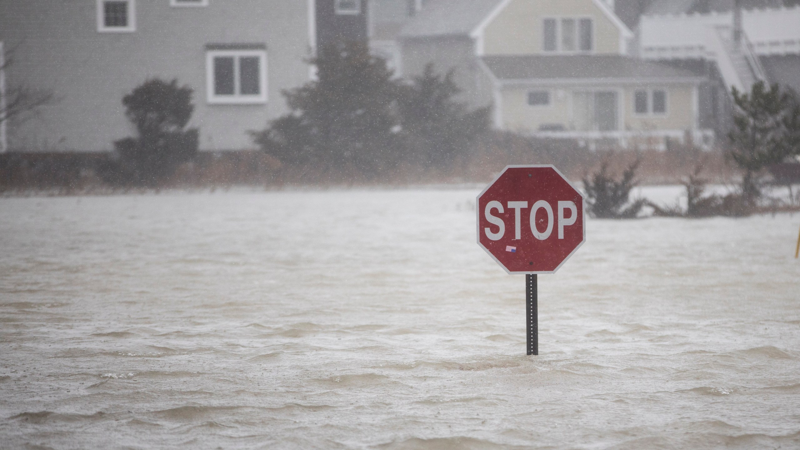 A flooded out road with a stop sign as a large coastal storm bears down on the region on March 2, 2018 in Scituate, Massachusetts. (Credit: Scott Eisen/Getty Images)