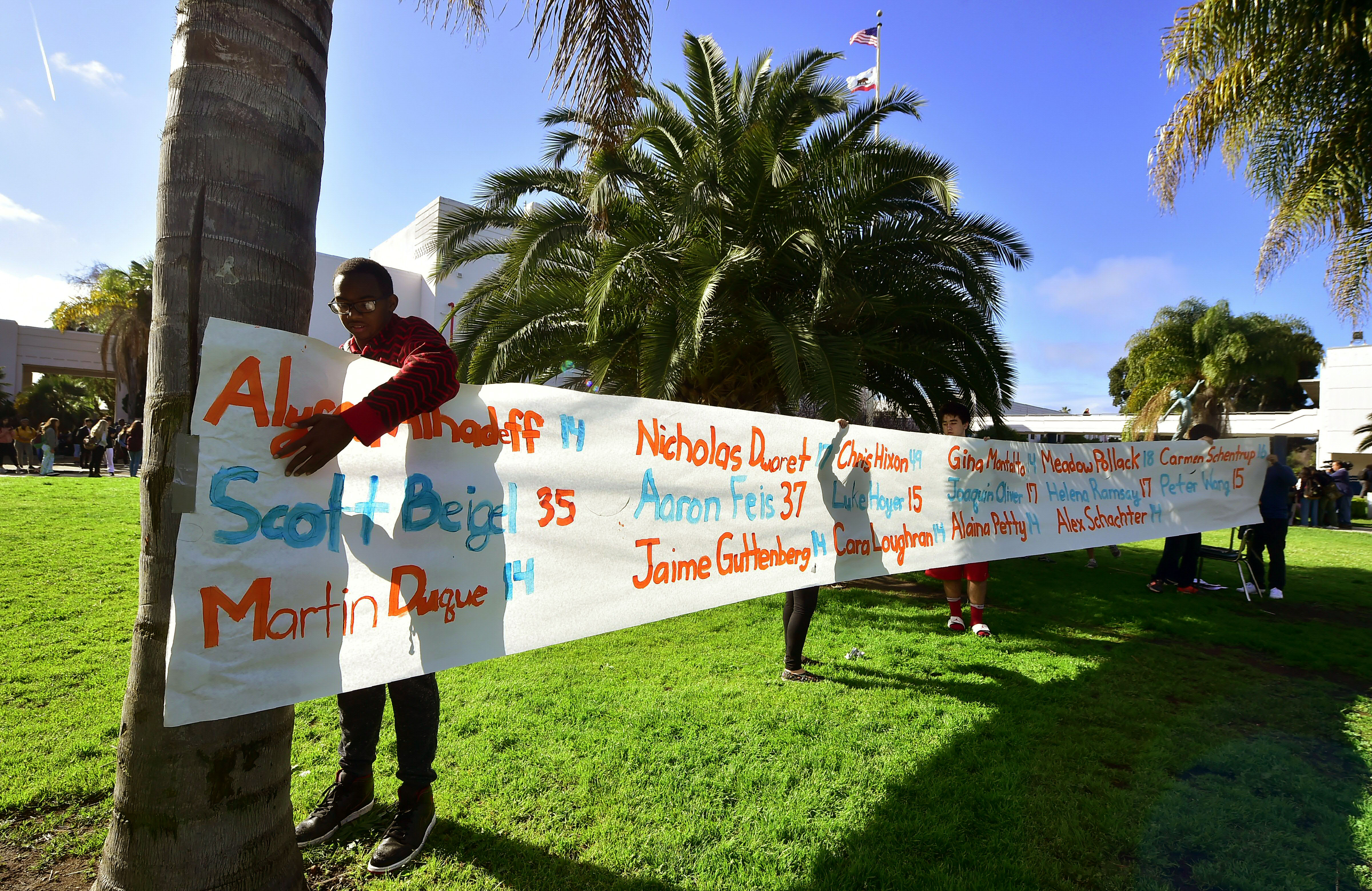 A banner is displayed bearing the names of the 17 Parkland victims on March 14, 2018, as students from Venice High School join others in a nationwide walkout to protest gun violence. (Credit: FREDERIC J. BROWN/AFP/Getty Images)