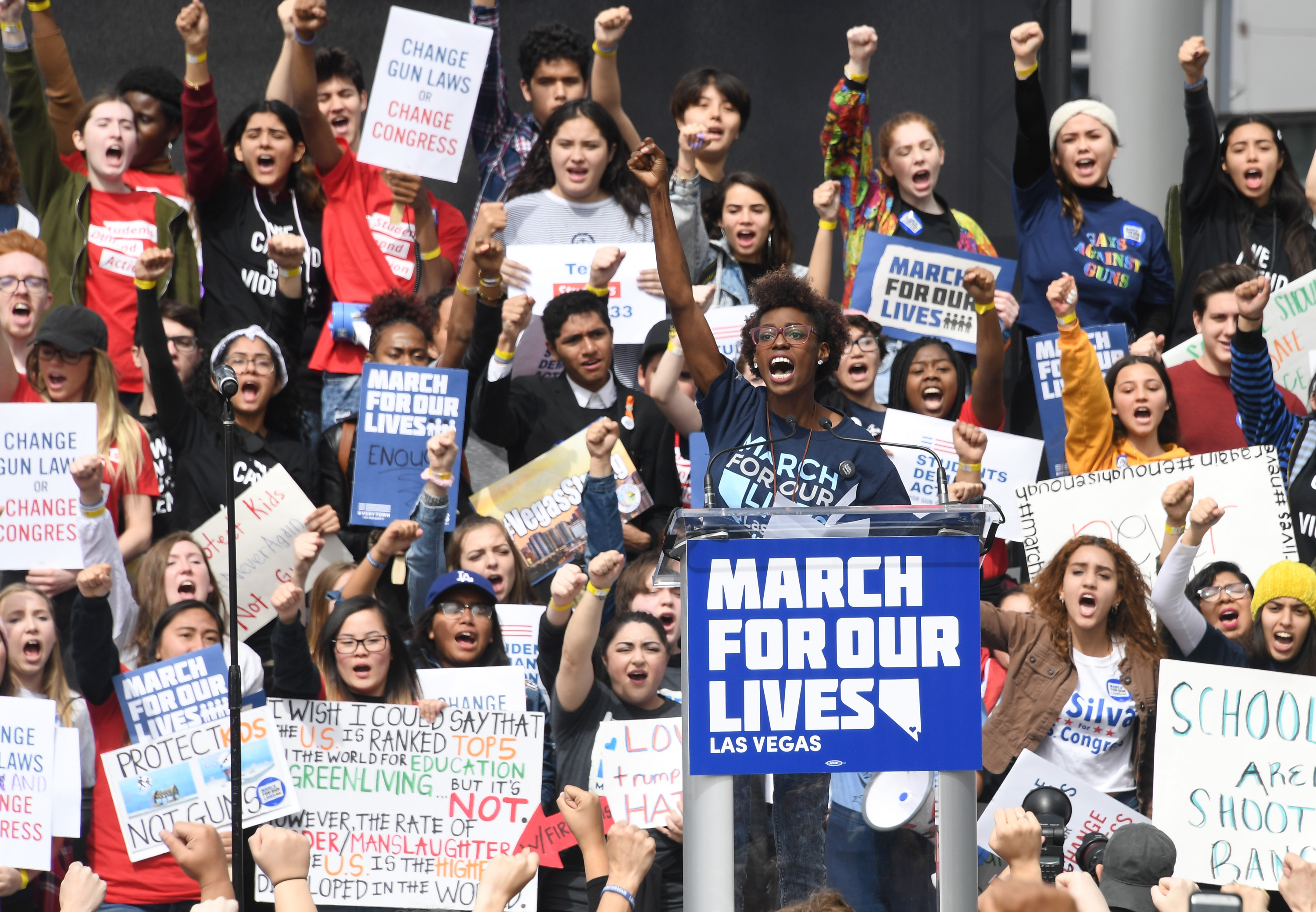 People raise their fists as organizer Denise Hooks speaks during the March for Our Lives rally at Las Vegas City Hall on March 24, 2018, in Las Vegas. (Credit: Ethan Miller/Getty Images)