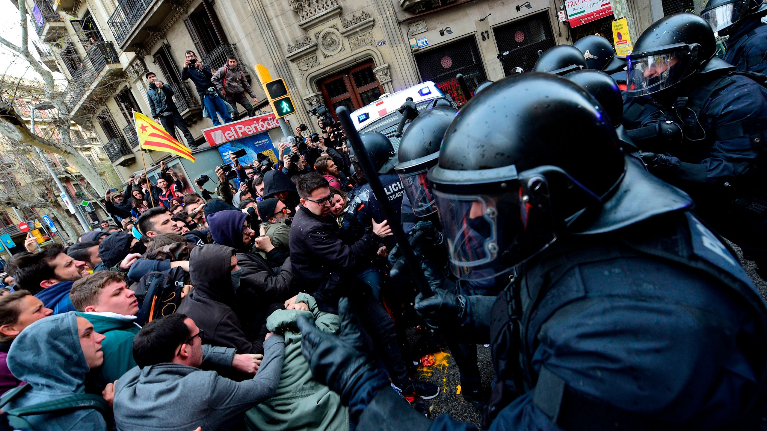 Protesters scuffle with police blocking the road leading to the central government offices at a demonstration in Barcelona on March 25, 2018 after Catalonia's former president was arrested by German police. (Credit: LLUIS GENE/AFP/Getty Images)