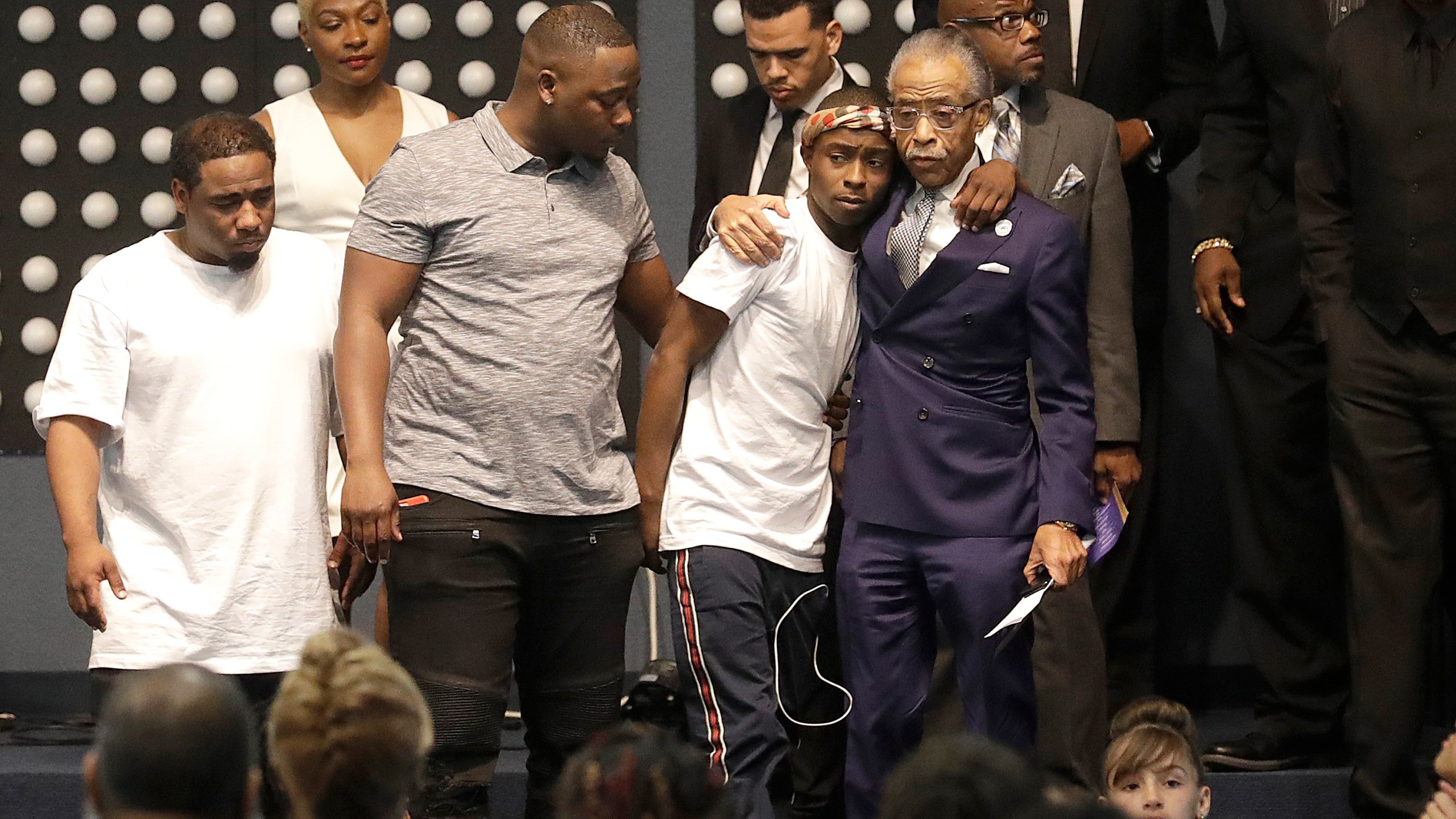 Rev. Al Sharpton, center right, hugs Stevante Clark during the funeral services for his brother, Stephon Clark, at Bayside Of South Sacramento Church on March 29, 2018. (Credit: Jeff Chiu-Pool/Getty Images)