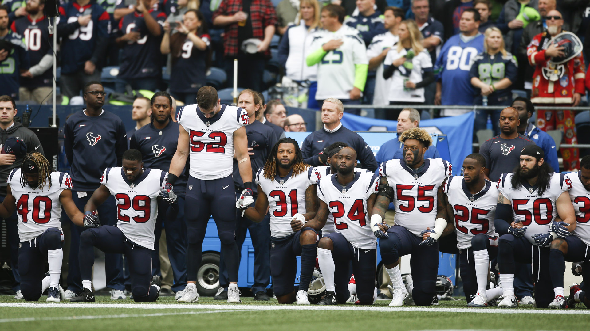 Members of the Houston Texans stand and kneel before the game against the Seattle Seahawks at CenturyLink Field on October 29, 2017 in Seattle. (Credit: Otto Greule Jr/Getty Images)