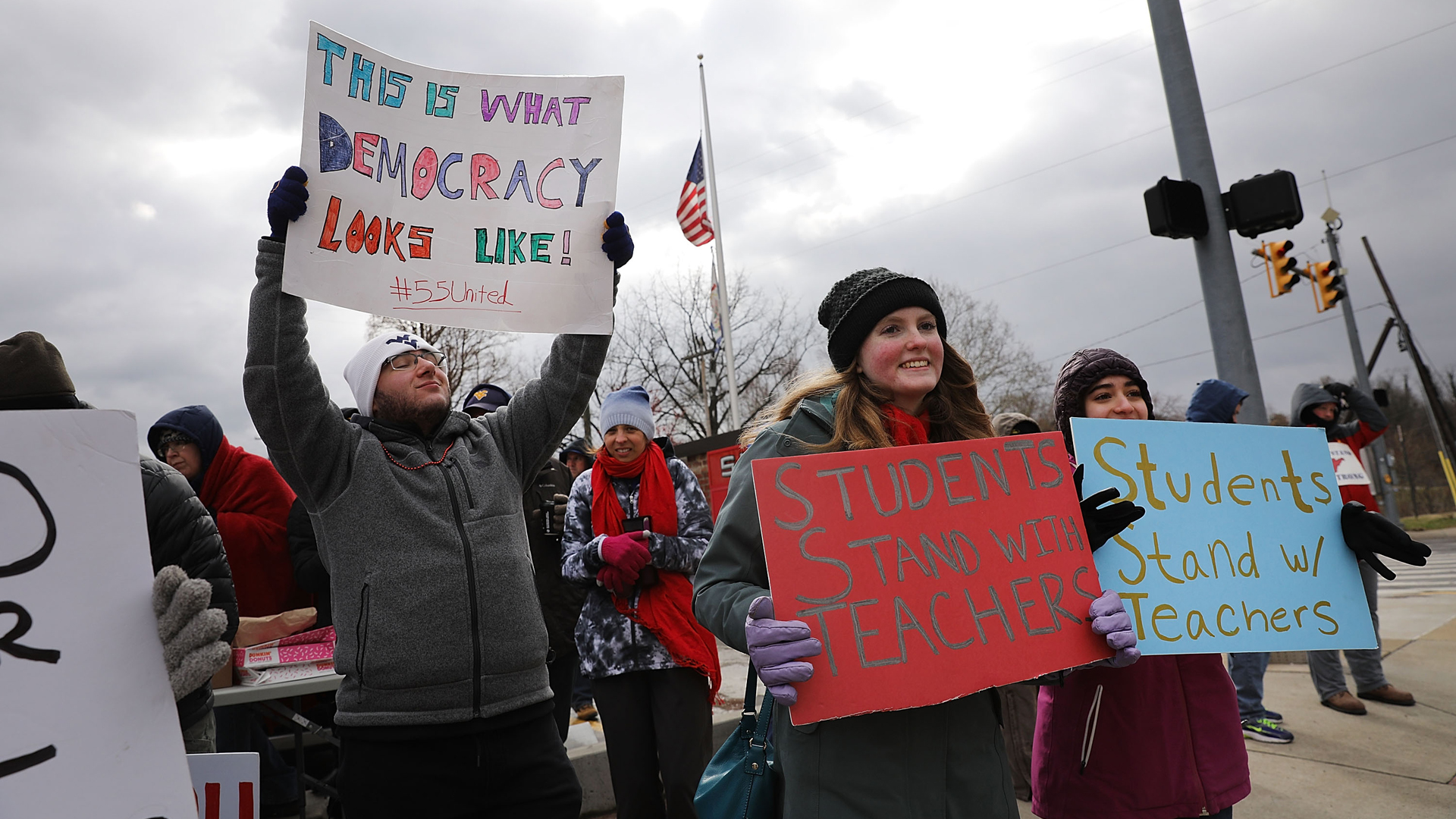 Teachers, students and supporters hold signs on a Morgantown street as they continue their strike on March 2, 2018 in Morgantown, West Virginia. (Credit: Spencer Platt/Getty Images)