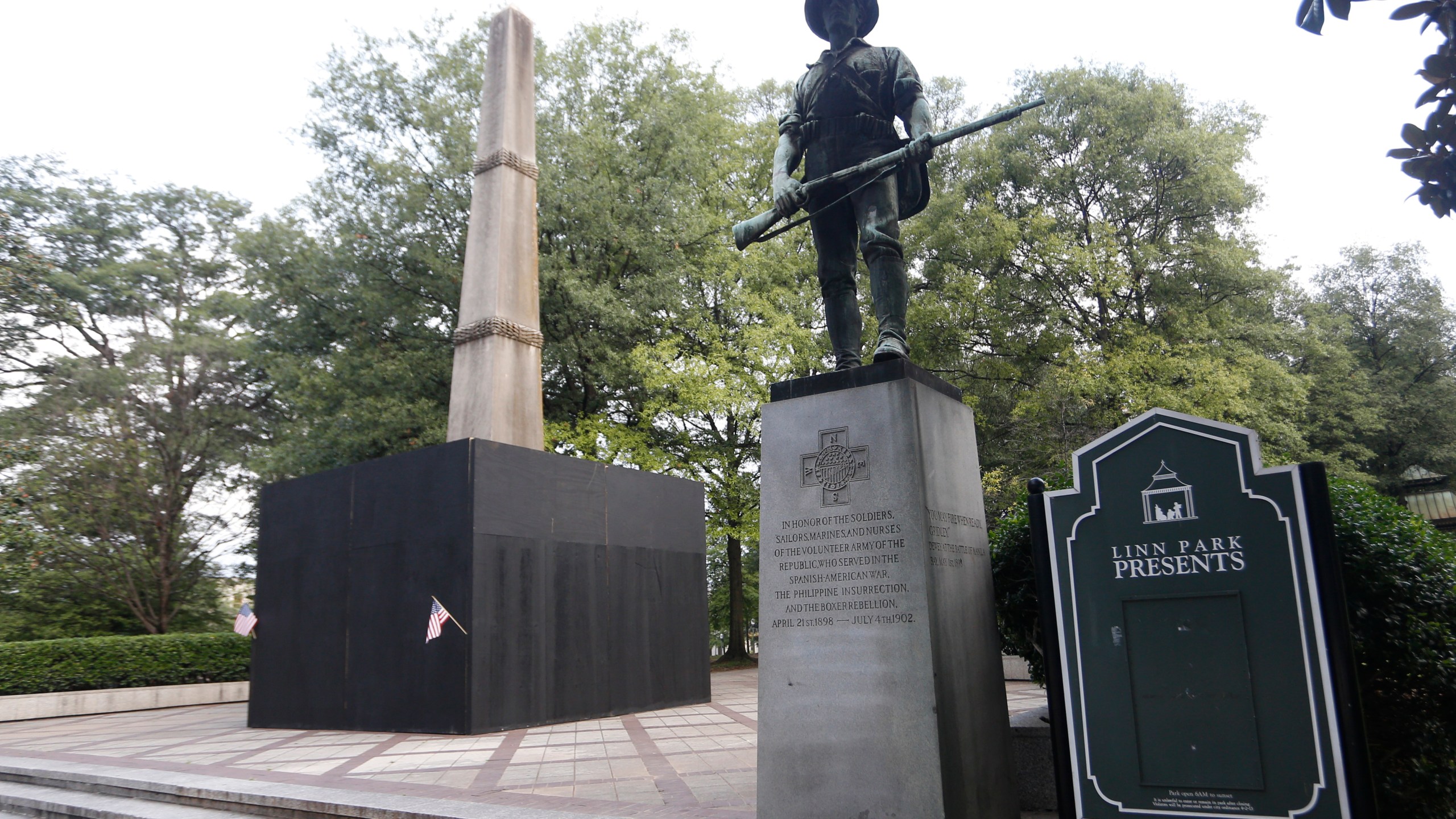 A monument to volunteers of the Army of the Republic stands next to a confederate monument covered up by the mayor of Birmingham in Linn Park August 18, 2017 in Birmingham, Alabama. (Credit: Hal Yeager/Getty Images)