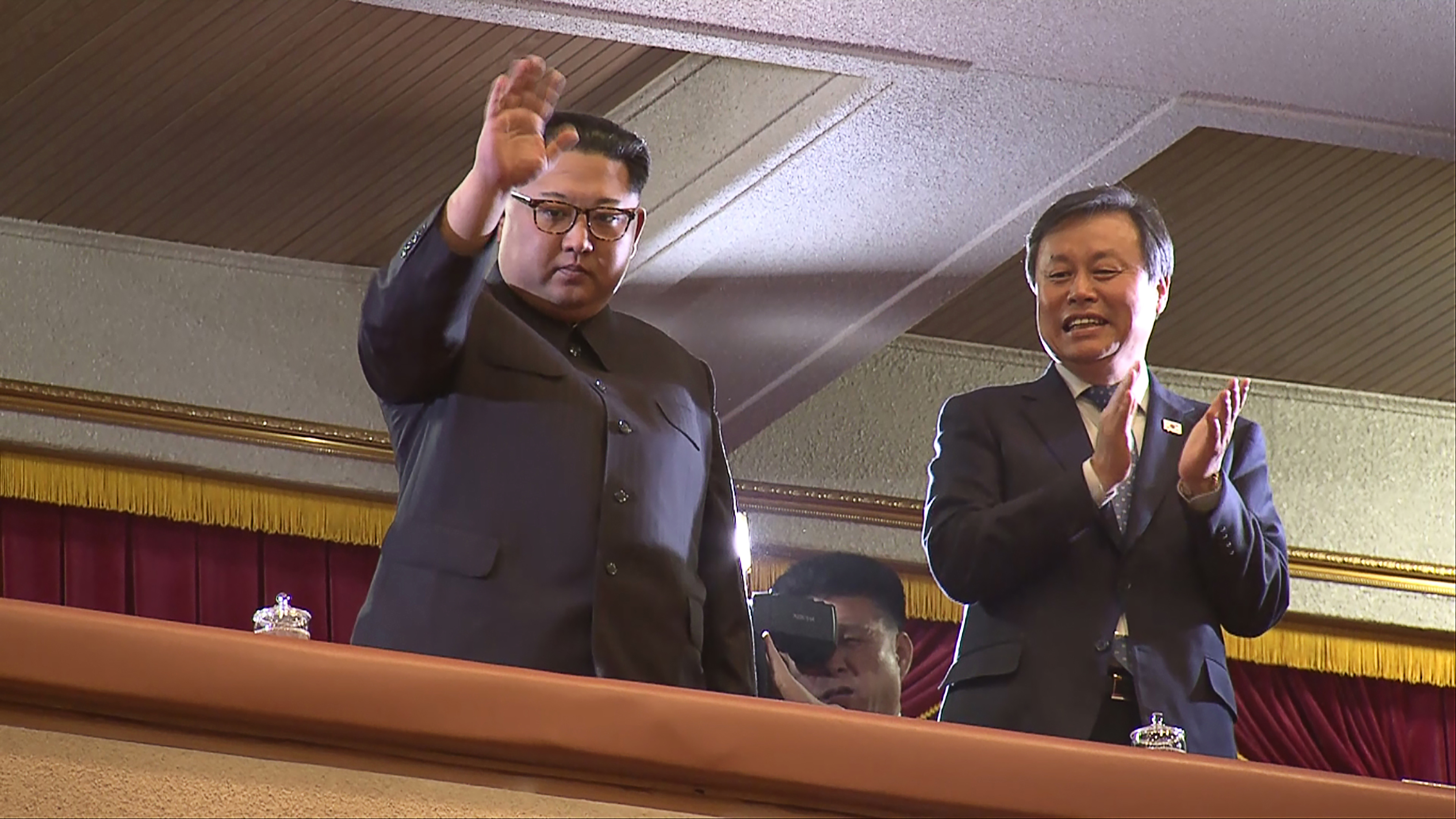 This picture captured from a video footage by Korea Pool reporters shows North Korean leader Kim Jong Un (left) and South Korea's Culture, Sports and Tourism Minister Do Jong-whan (right) during a rare concert by South Korean musicians at the 1,500-seat East Pyongyang Grand Theatre in Pyongyang on April 1, 2018. (Credit: AFP/ Getty Images/KOREA POOL)