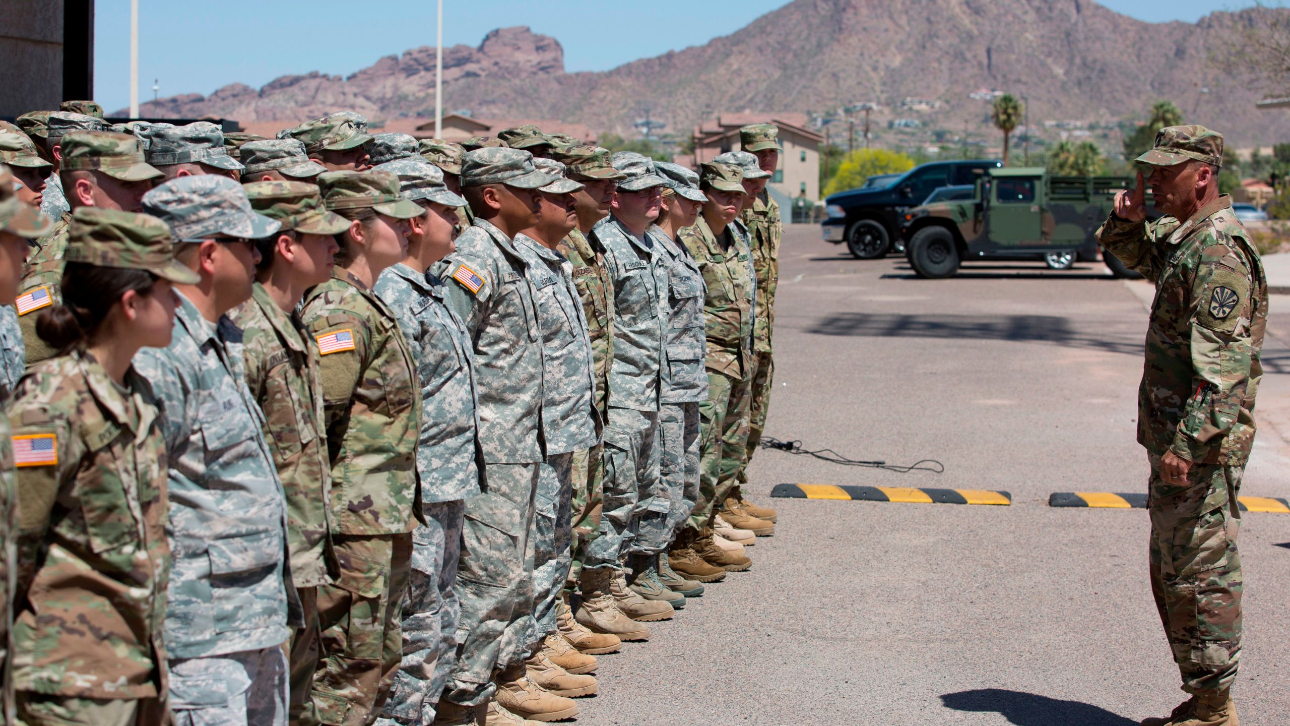 Members of the Arizona National Guard listen to instructions on April 9, 2018, at the Papago Park Military Reservation in Phoenix. (Credit: Caitlin O'Hara / AFP / Getty Images)