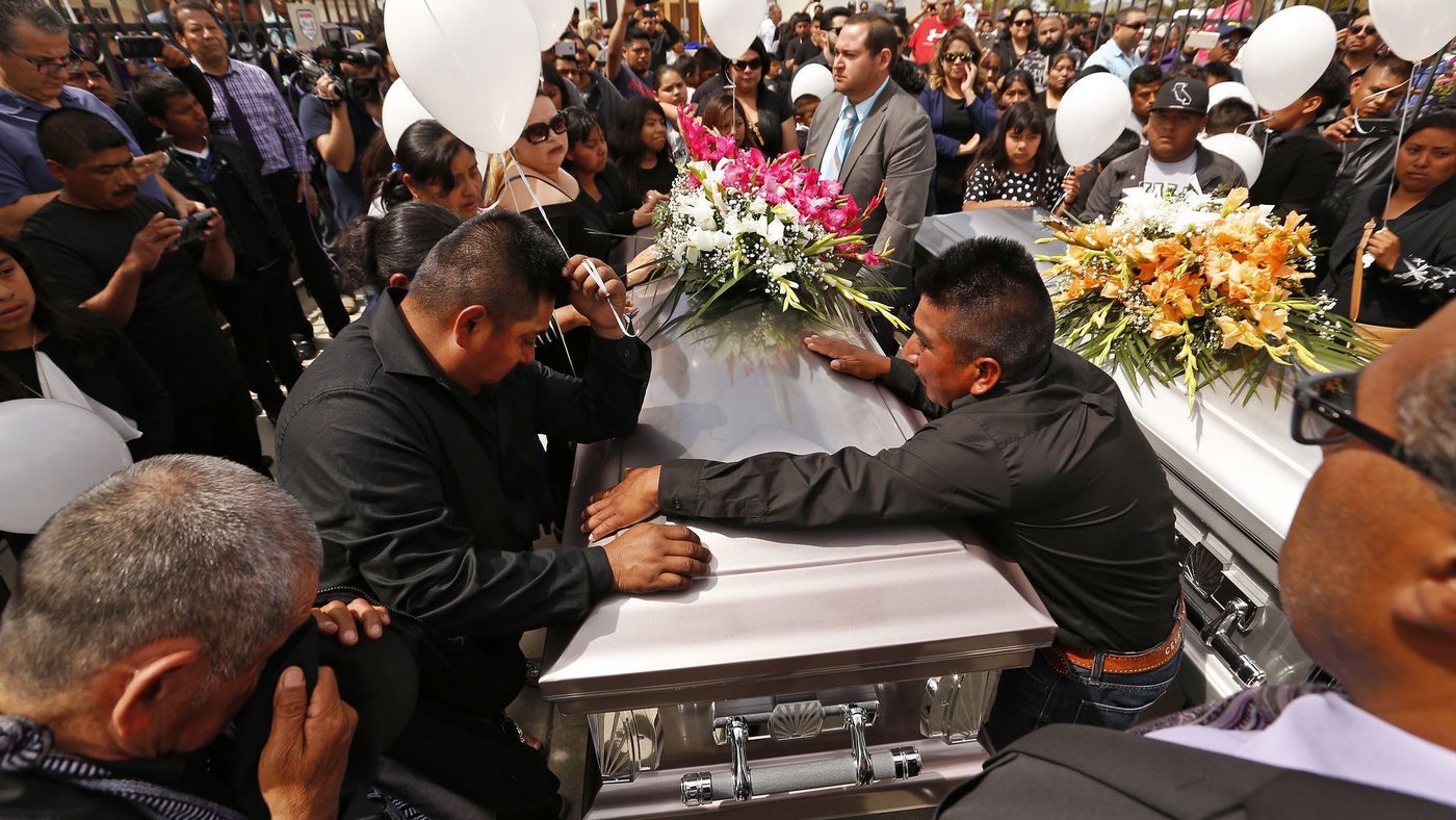 The brothers of Santos Hilario Garcia grieve during funeral services at Our Lady of Guadalupe Church in Delano for Garcia and Marcelina Garcia Perfecto, who were killed when their car overturned while fleeing federal immigration agents. (Credit: Al Seib / Los Angeles Times)