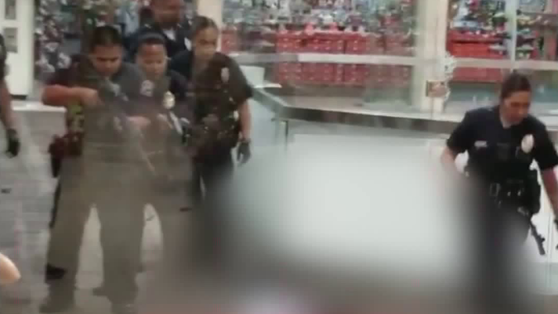 Police officers are seen approaching a man's body after they fatally shot him at the Baldwin Hills Crenshaw Plaza on April 10, 2018. (Credit: @biggstah10 via Instagram)