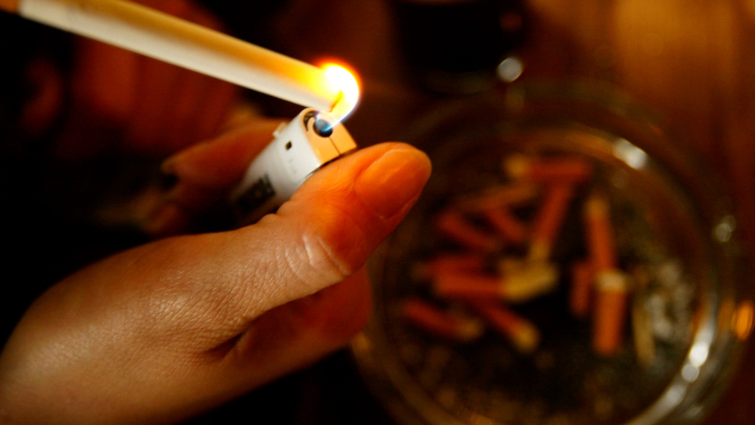 A girl lights up a cigarette in this file photo taken on January 9, 2004. (Credit: Graeme Robertson/Getty Images)