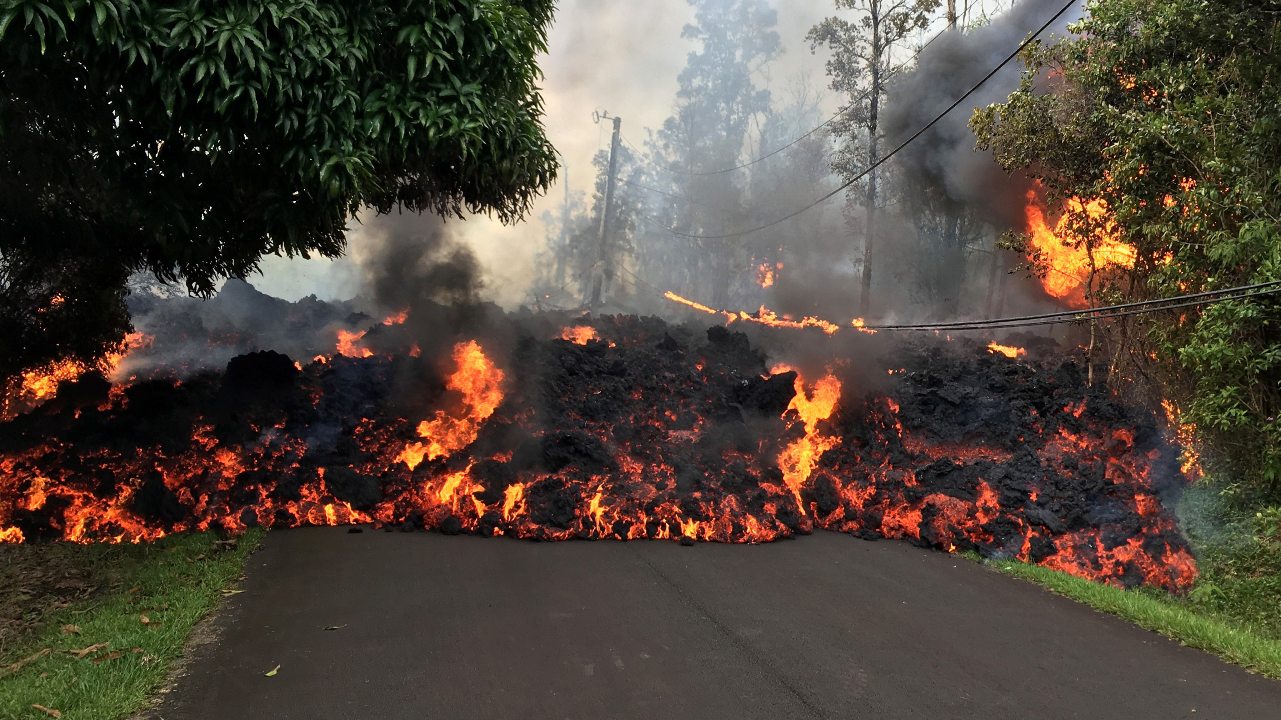 In this handout photo provided by the U.S. Geological Survey, a lava flow moves on Makamae Street after the eruption of Hawaii's Kilauea volcano on May 6, 2018 in the Leilani Estates subdivision near Pahoa, Hawaii. (Credit: U.S. Geological Survey via Getty Images)