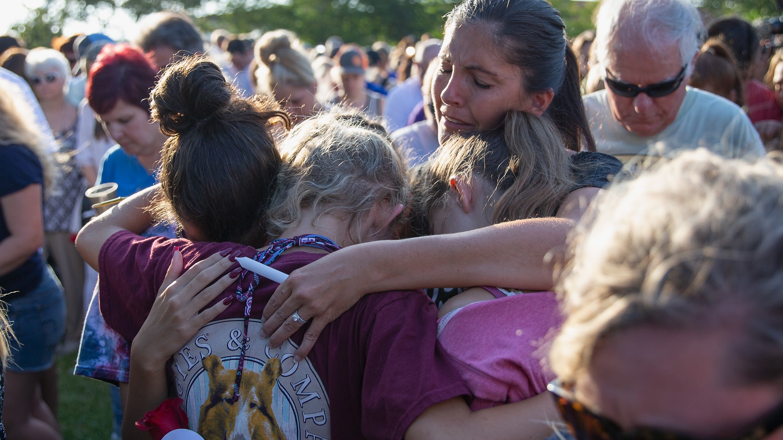 Friends and family attend a vigil held at the First Bank in Santa Fe for the victims of a shooting incident at Santa Fe High School, where a shooter killed at least 10 students on May 18, 2018, in Santa Fe, Texas. (Credit: Bob Levey / Getty Images)