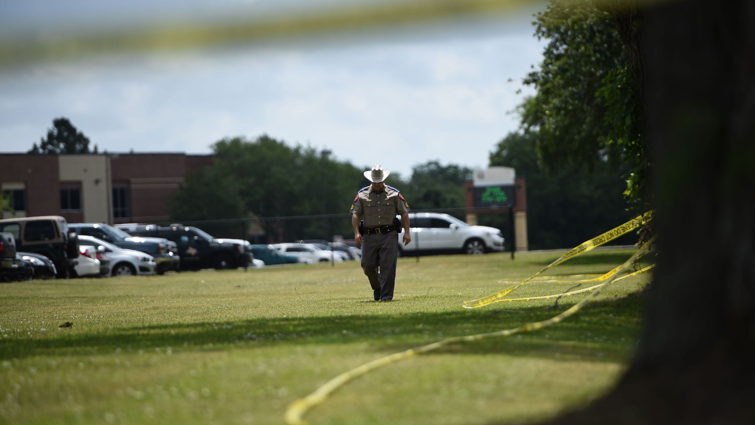 Police officers patrol outside Santa Fe High School on May 19, 2018, in Santa Fe, Texas. (Credit: BRENDAN SMIALOWSKI/AFP/Getty Images)